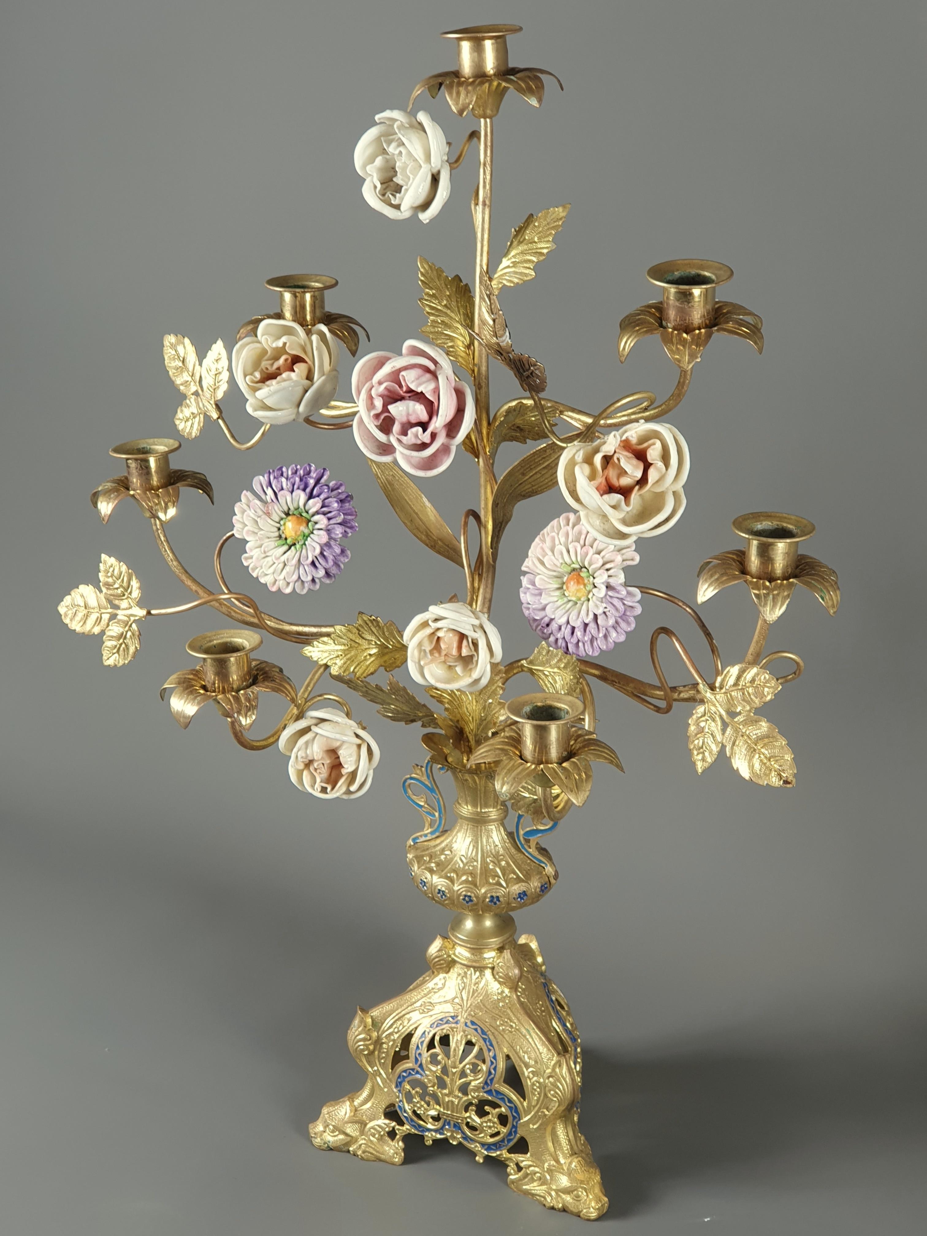 Pair of large candlesticks with seven arms of light in gilded bronze and royale blue rechampi.

Rich vegetal and floral decoration composed of polychrome porcelain branches and flowers.

Very finely crafted tripod base.

19th century