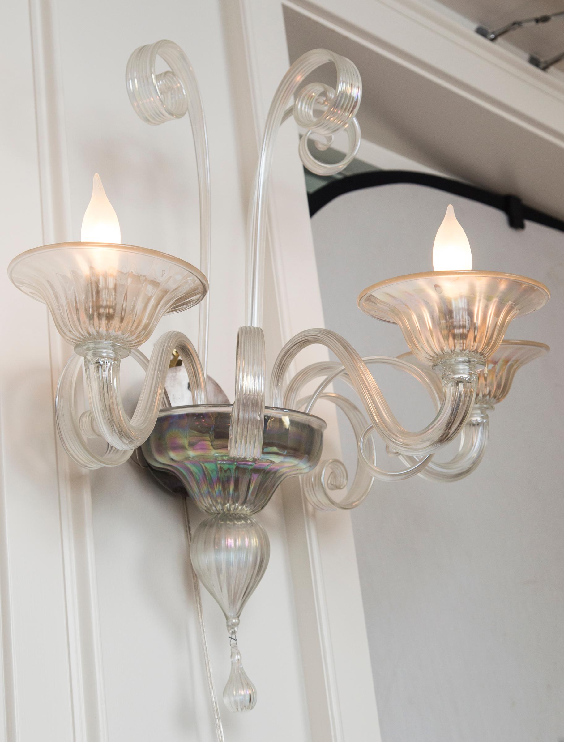 Large pair of iridescent blown three light sconces with matte nickel sockets, newly electrified to code with new UL approved matte nickel sockets, not install ready.
Minimal detailing with lovely reeded textured glass and soft swirling