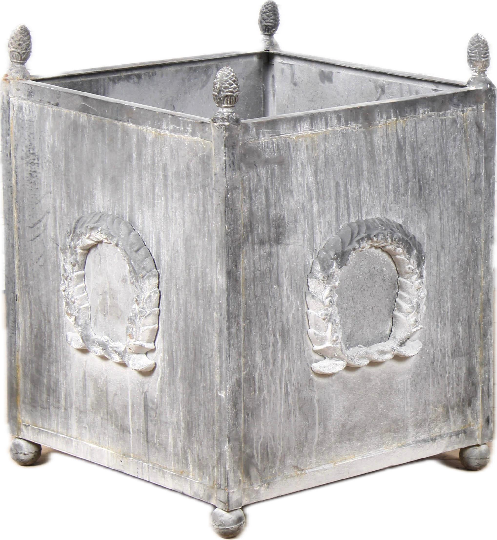 Pair of Classical metal planters with wreath motif.  A pair of American Neoclassical style metal planters with grey patinated color, laurel wreath motifs, acorns and ball feet. This pair of metal planters with a Neoclassical influence and simple