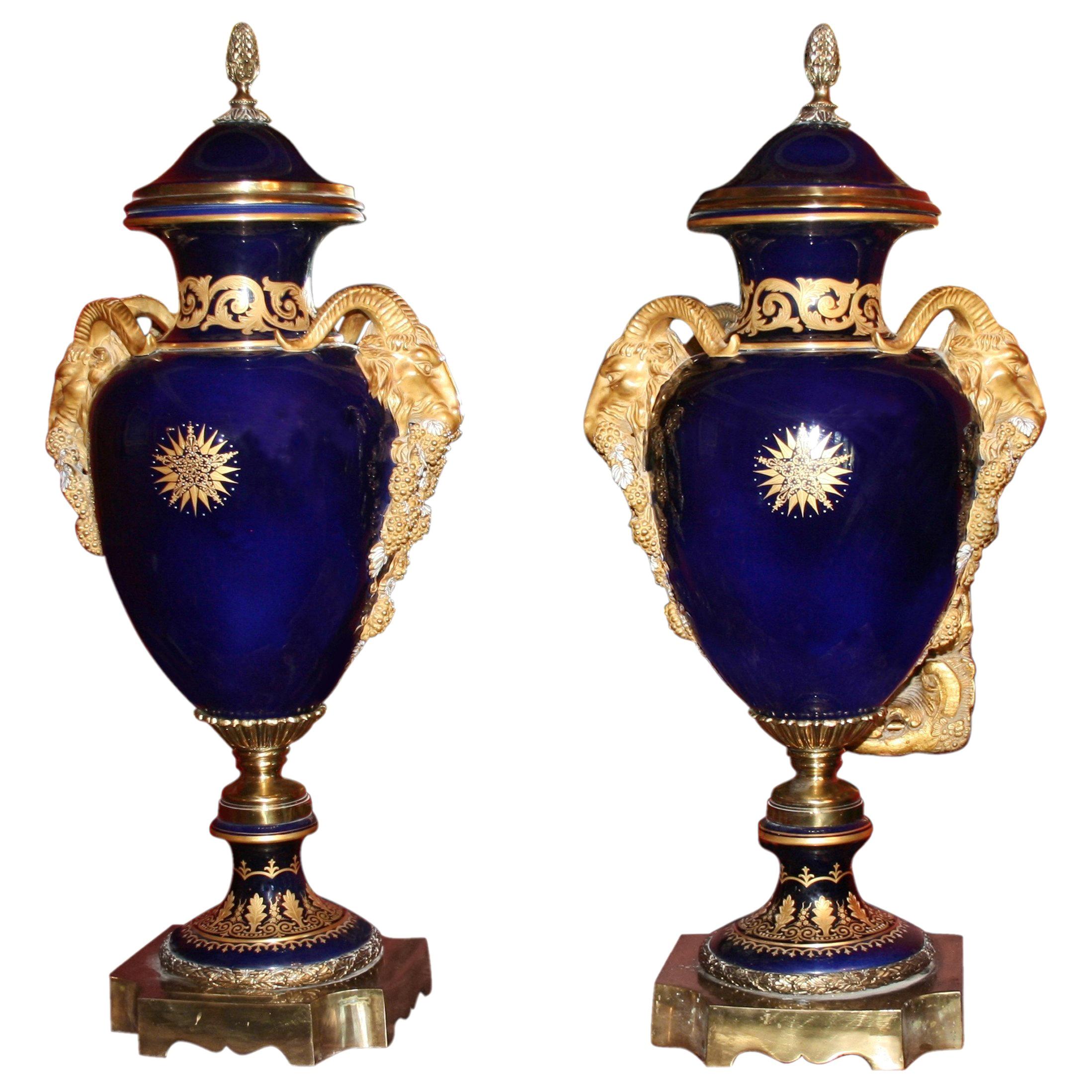 Pair of Large Cobalt Blue Lidded Urns with Gilt Rams Head Handles For Sale