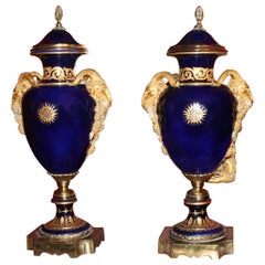 Pair of Large Cobalt Blue Lidded Urns with Gilt Rams Head Handles