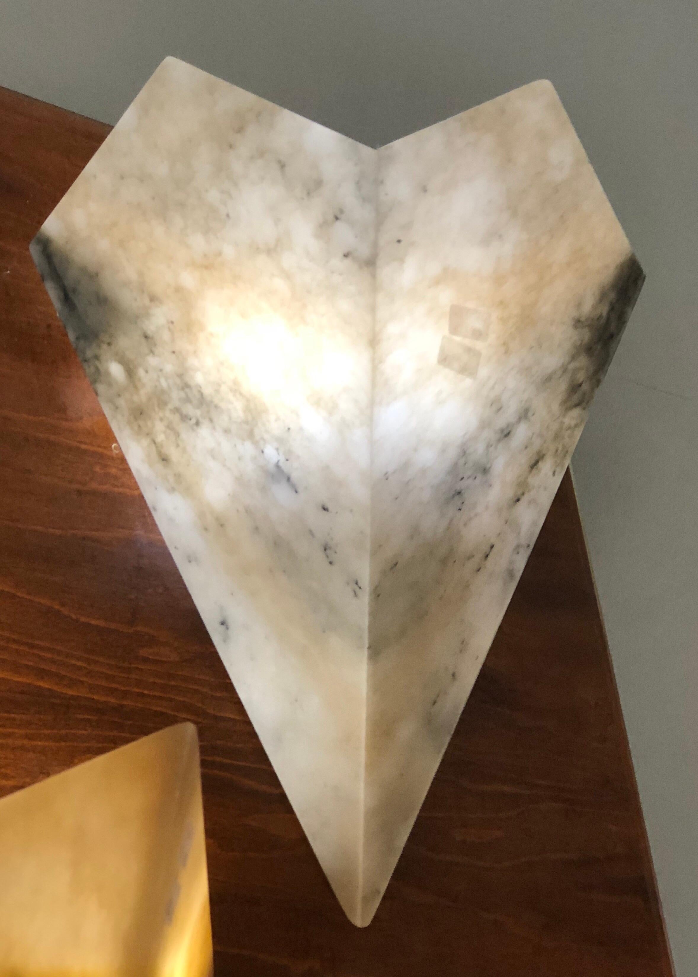 Elegant pair of large Italian Modern Neoclassical style alabaster wall lights / sconces with white / grey and yellow veining. The pieces are delicately angled reflecting French Art Deco, Mid-Century and Neoclassical aesthetics.  They are timeless,