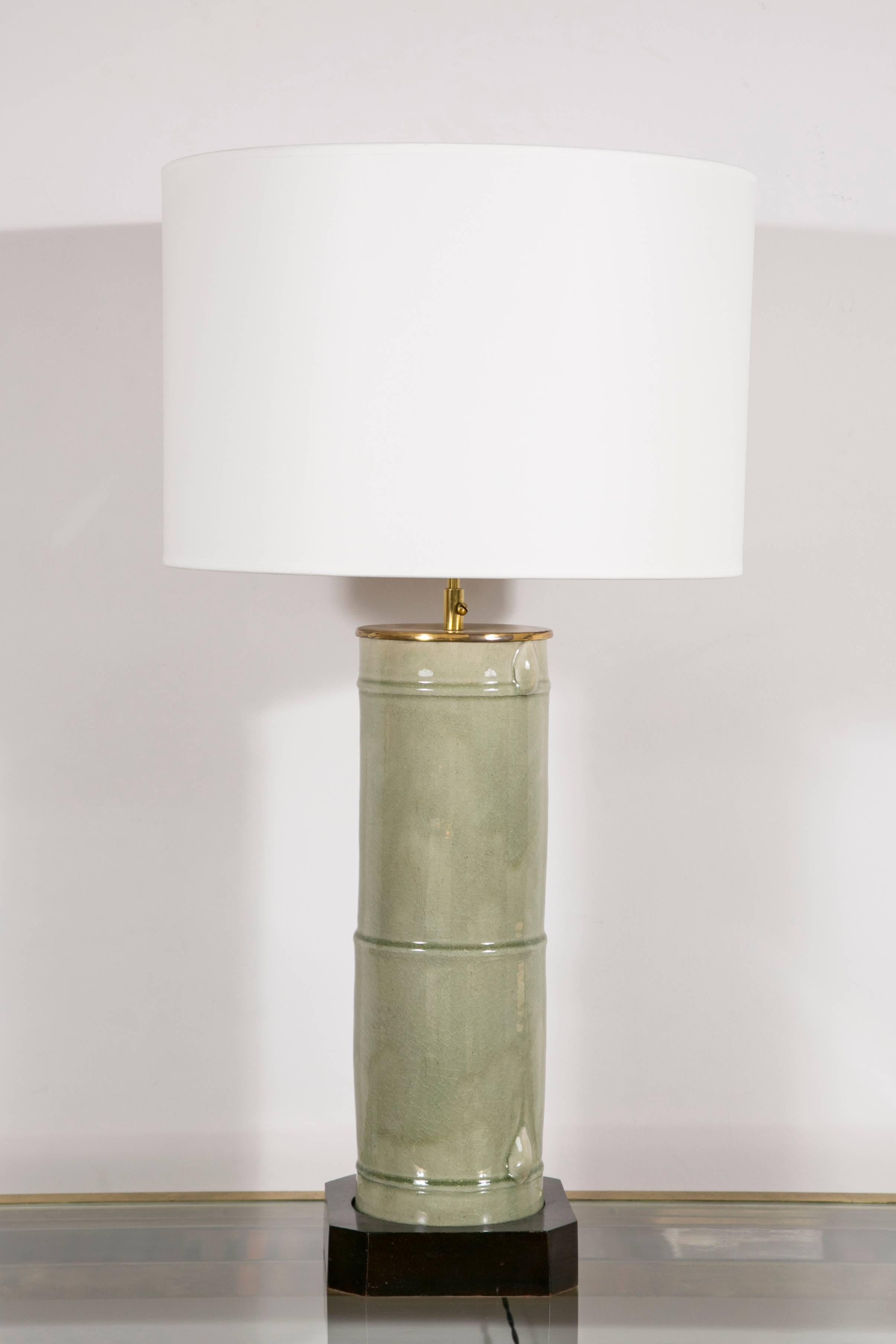 A pair of celadon lamps, figuring a bamboo stem.
Mounted on a black lacquered wood base.
Adjustable height.
New shades.
France, 1940s

The celadon may be older. 

Dimensions : 
Height (total) between 81 cm and 88 cm / 31.88 in. and 34.64