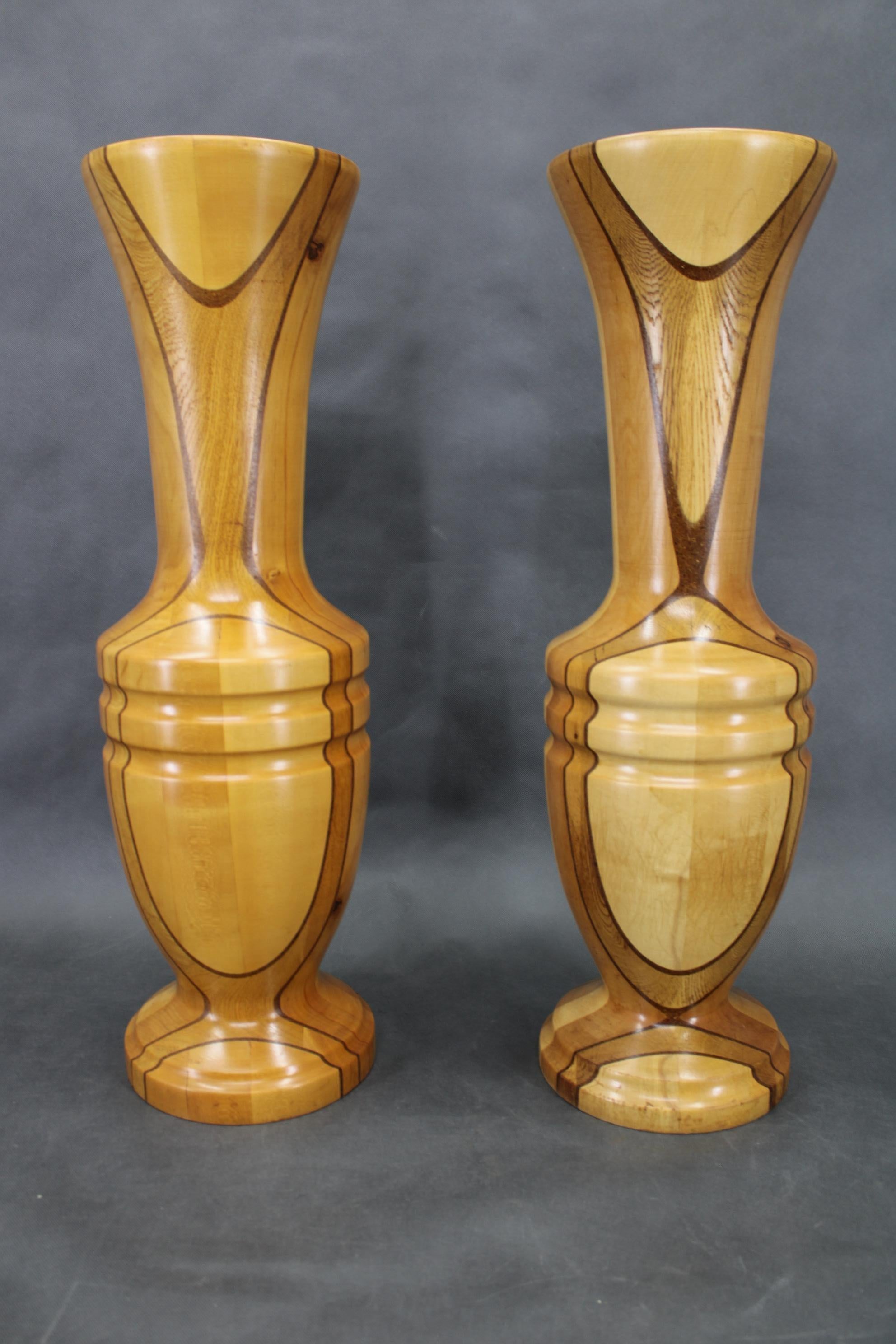 Pair of striking large vases handcrafted in Czechoslovakia circa 1960s, expertly composed from a combination of various solid woods. Each stands 80 cm high with a 24 cm diameter, revealing unique grain patterns and a sculptural form. 
Both are