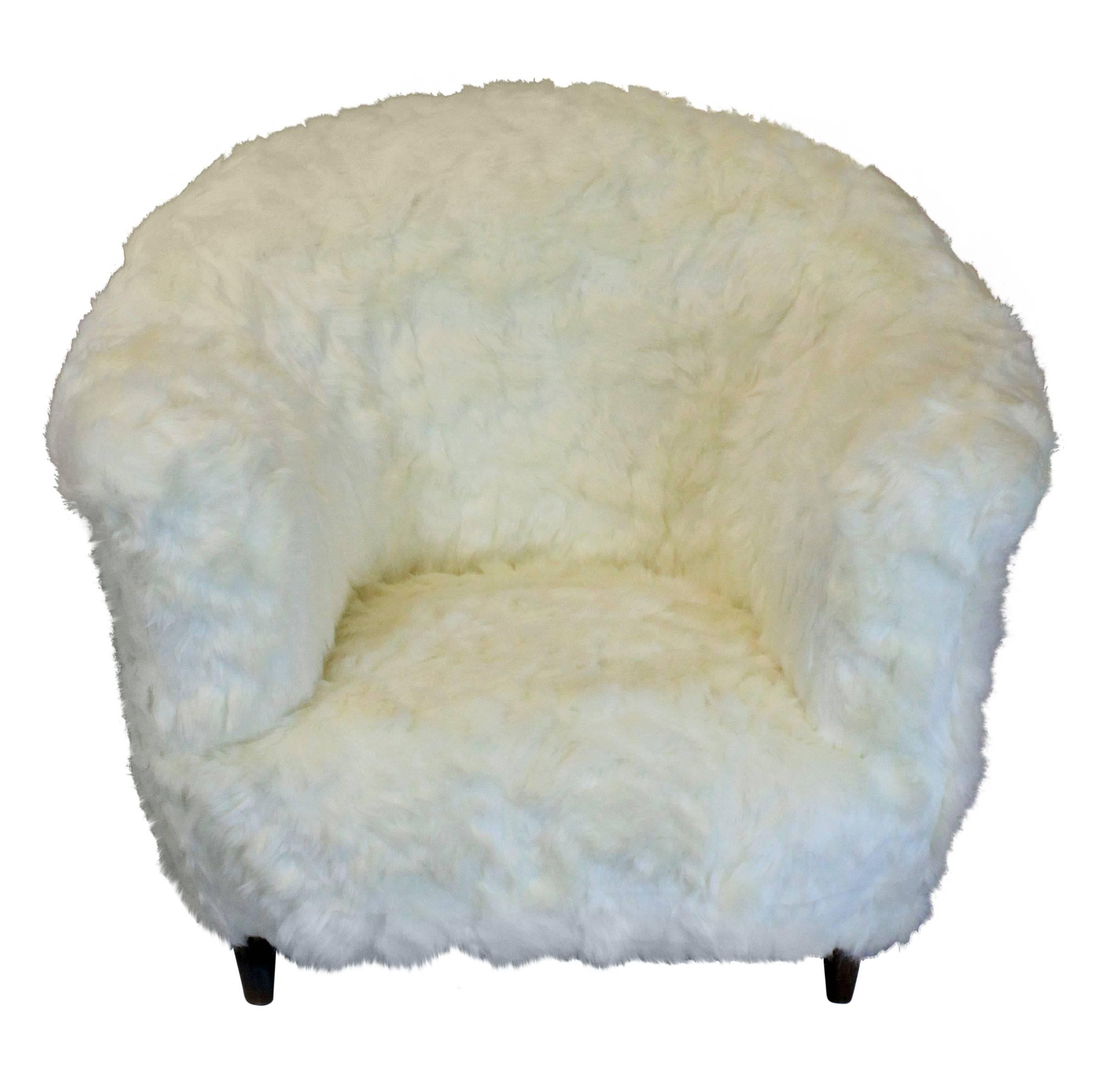 A pair of large Danish armchairs in ivory colored faux fur. Very comfortable and generous in scale.

 