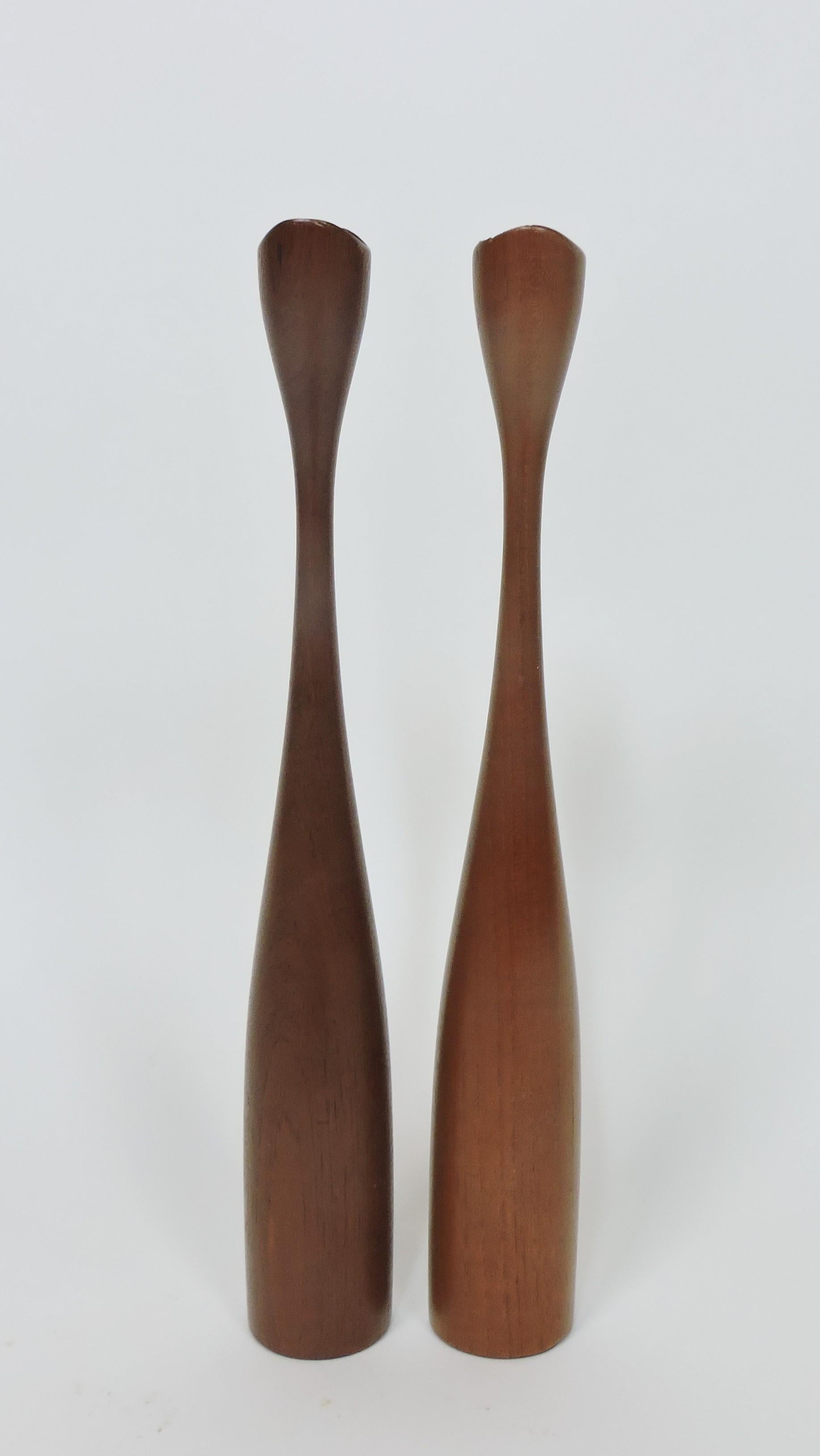 Beautiful and elegant pair of Danish Modern solid teak turned candleholders. These candlesticks are exceptionally large at 16 1/2 inches tall, and with their graceful shape will make quite a statement! 