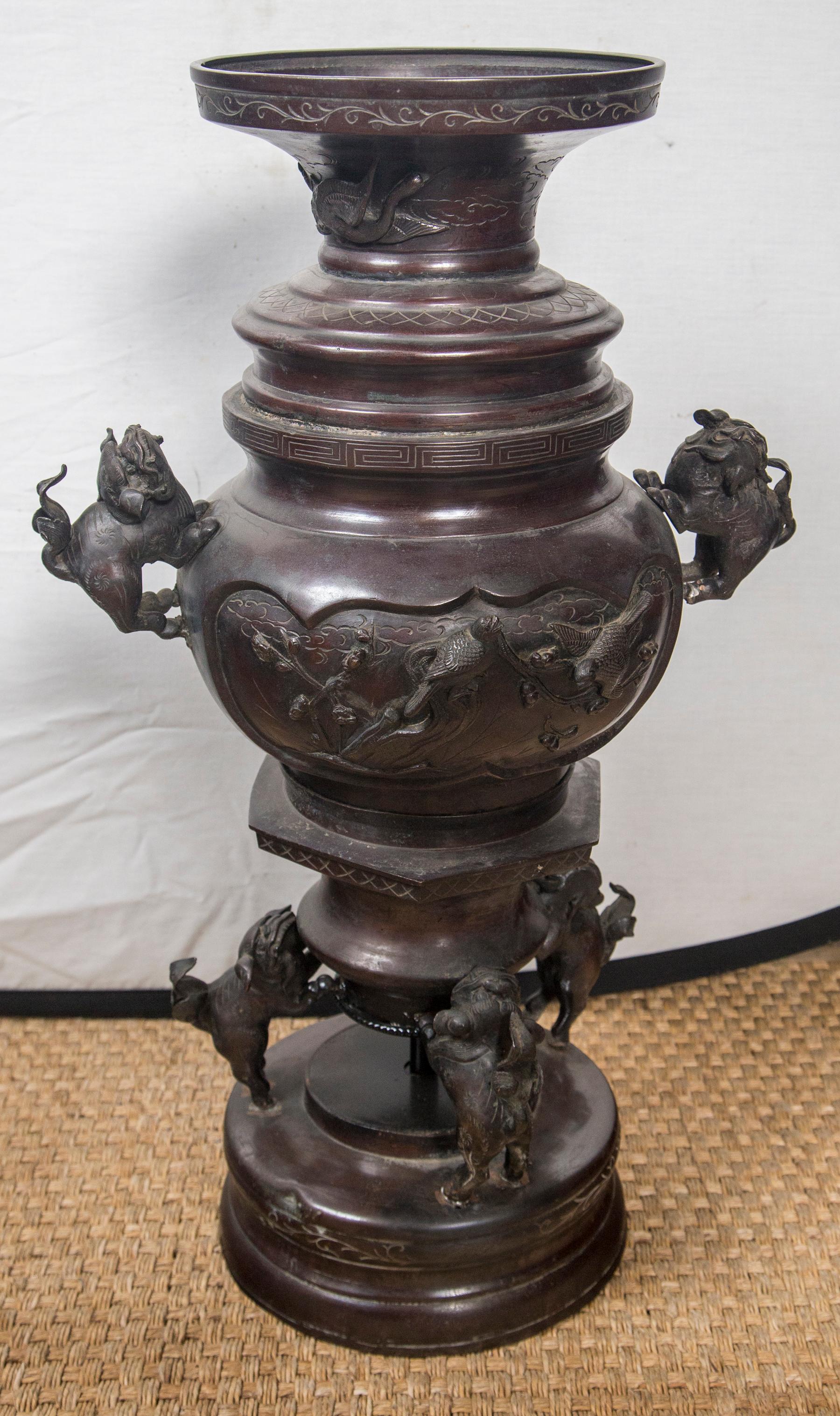 Well cast bronze vases, that have been converted to table lamps in the past. All mountings for lamps removed. Foo dog handles make the overall diameter 14.5 inches. Cartouches in relief of birds and fish (carp) and plants. Four foo dogs support the
