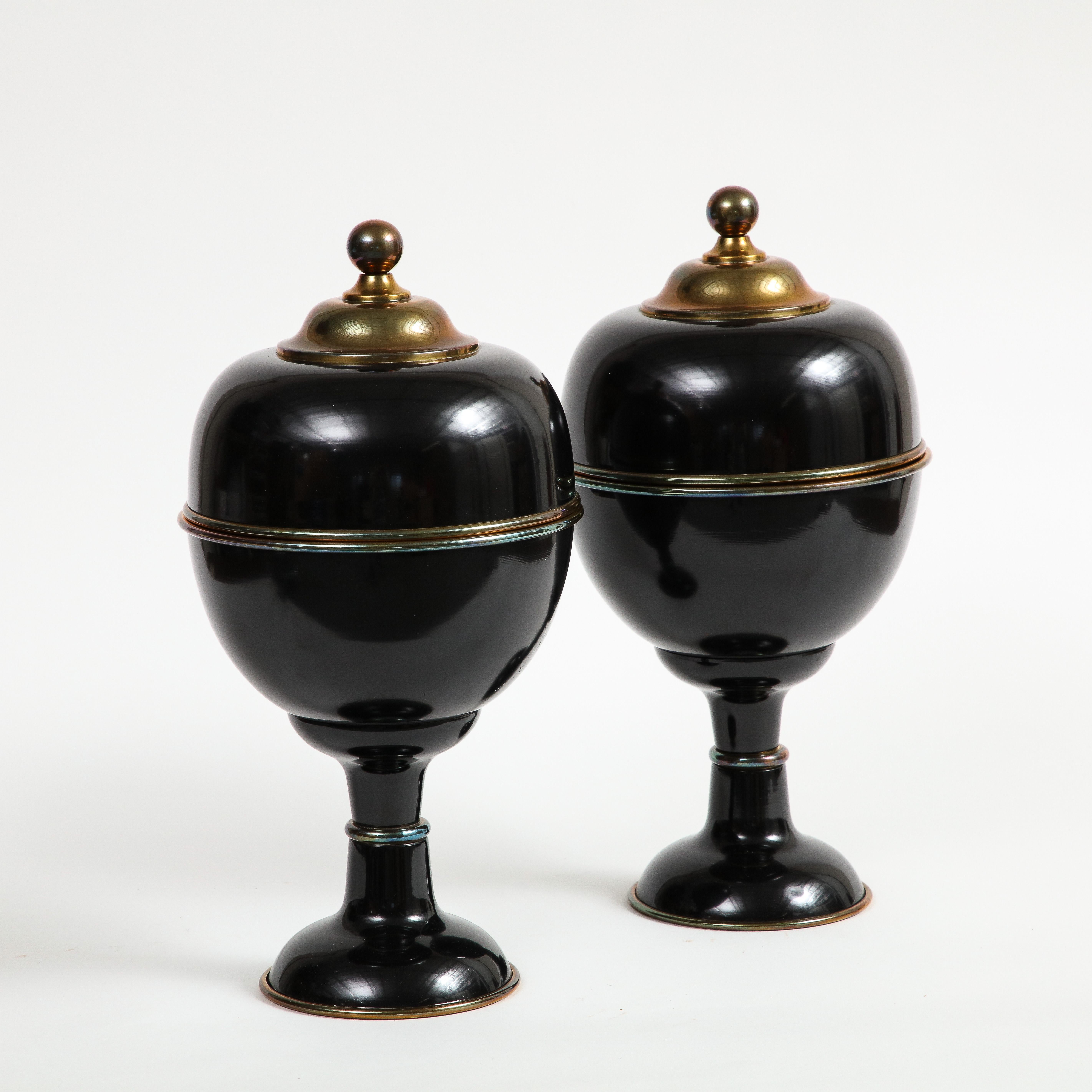 Pair of large decorative black enamel Guild Master urns with brass details. Interior is lined with brass. 

Additional Dimensions: 
bottom base 5.5
