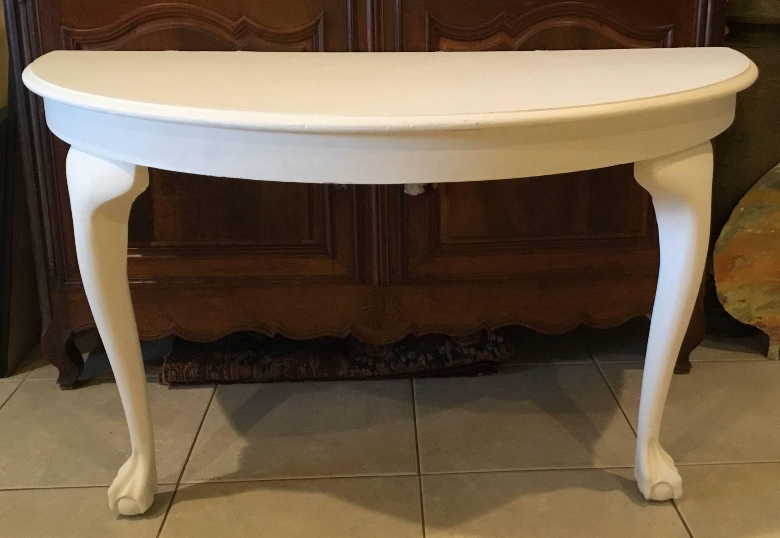 Pair of elegant console table made of mahogany wood with claw feet painted in white. This pair
was originally a large round table that was converted to a nice functional pair of console.