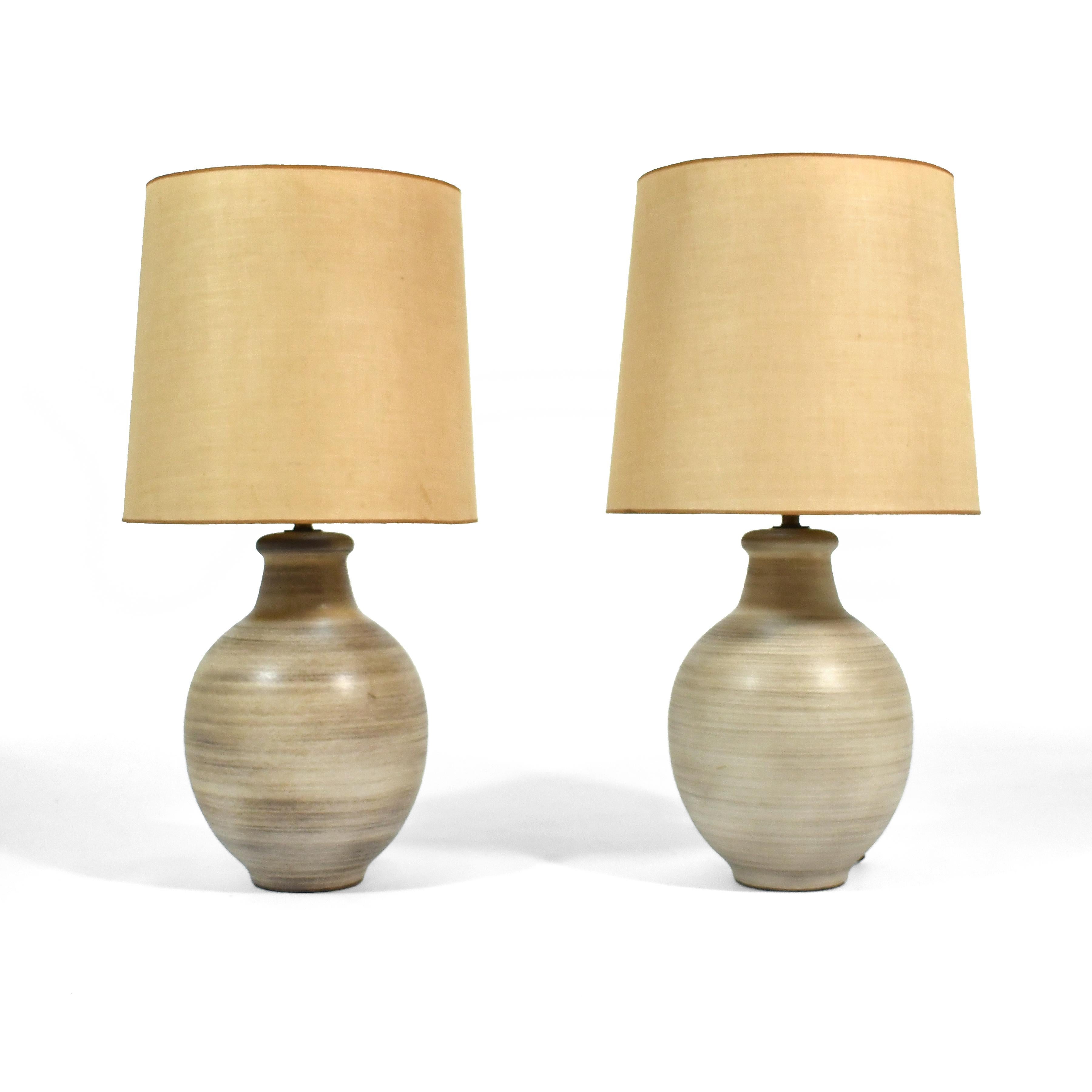 This pair of striking large Design Technics table lamps have a subtle earthy colored glaze with textured horizontal lines.

The original shades are in need of replacement, so the lamps are being sold sans shades.

33.5