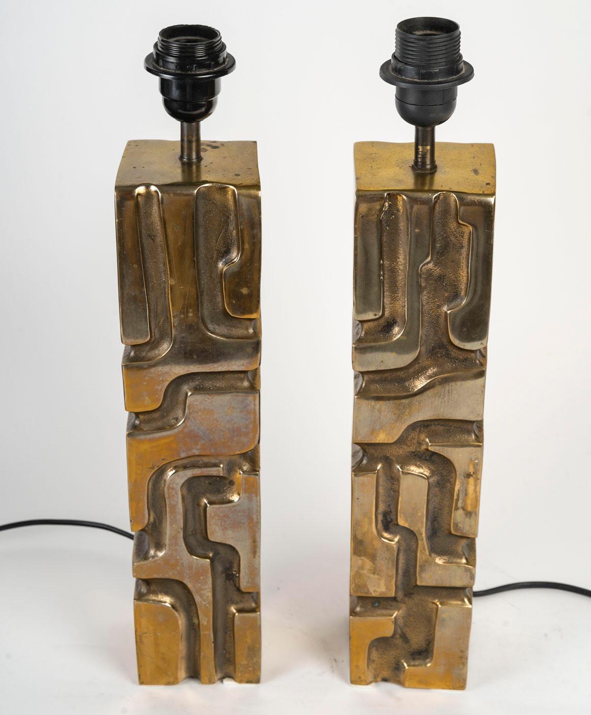 Pair of large desk lamps, bronze sculpture, signed by Michel Jaubert.

Sculpture, pair of bronze table lamps by Michel Jaubert, circa 1970, signed.
H: 49cm, W: 8.5cm, D: 8.5cm