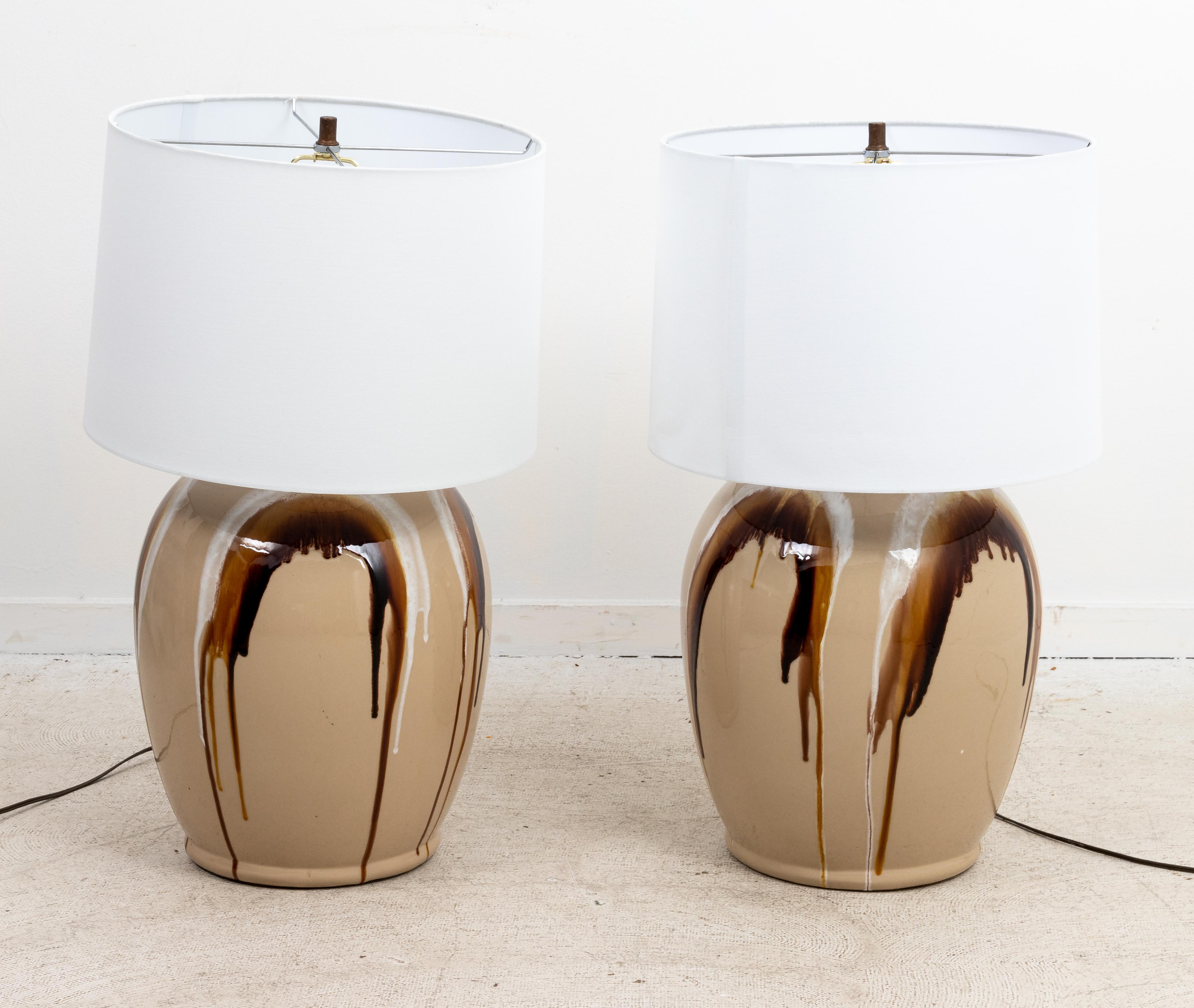 Circa 1970s pair of large Mid-Century Modern style drip glazed ceramic table lamps that measure 23.00 inches height to top of socket. Shades not included.