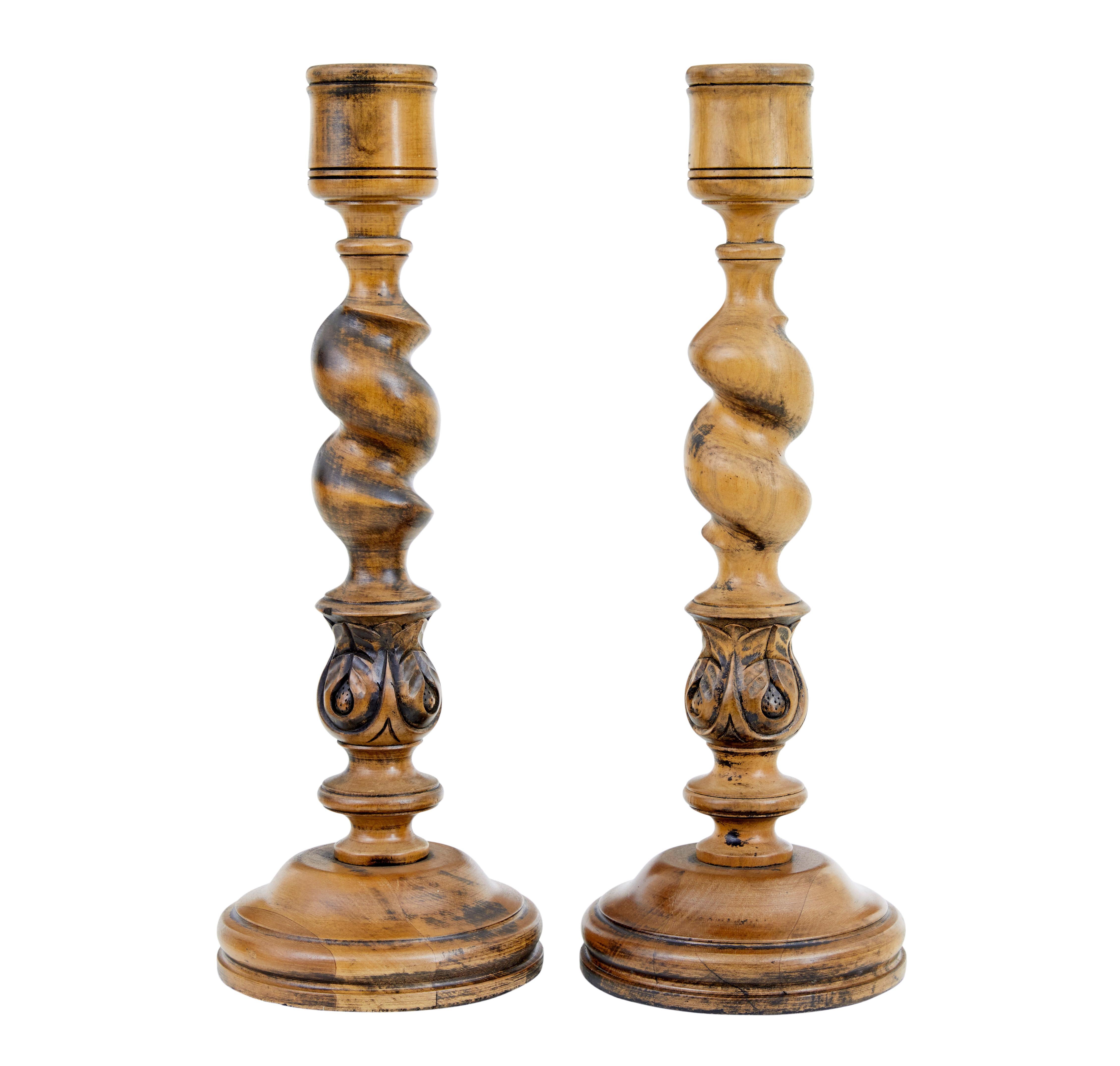 Pair of large early 20th century candlesticks circa 1920.

Good quality pair of hand carved candlesticks made from beech, very much in the gothic taste.

2 inch wide cup, twisted stem with bulbous acanthus leaf detail, standing on a round plinth