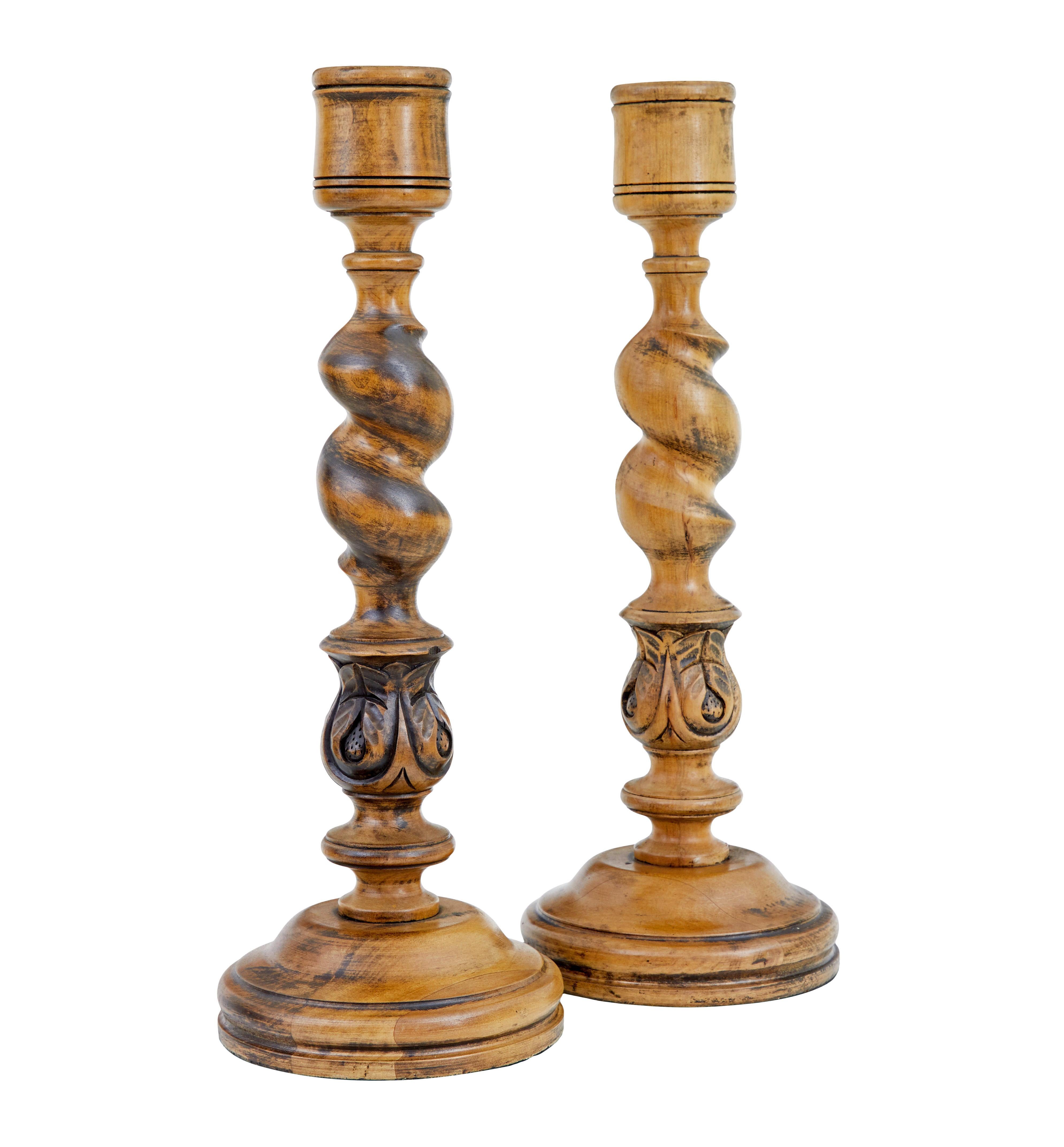 Pair of large early 20th century candlesticks circa 1920.

Good quality pair of hand carved candlesticks made from beech, very much in the gothic taste.

2 inch wide cup, twisted stem with bulbous acanthus leaf detail, standing on a round plinth