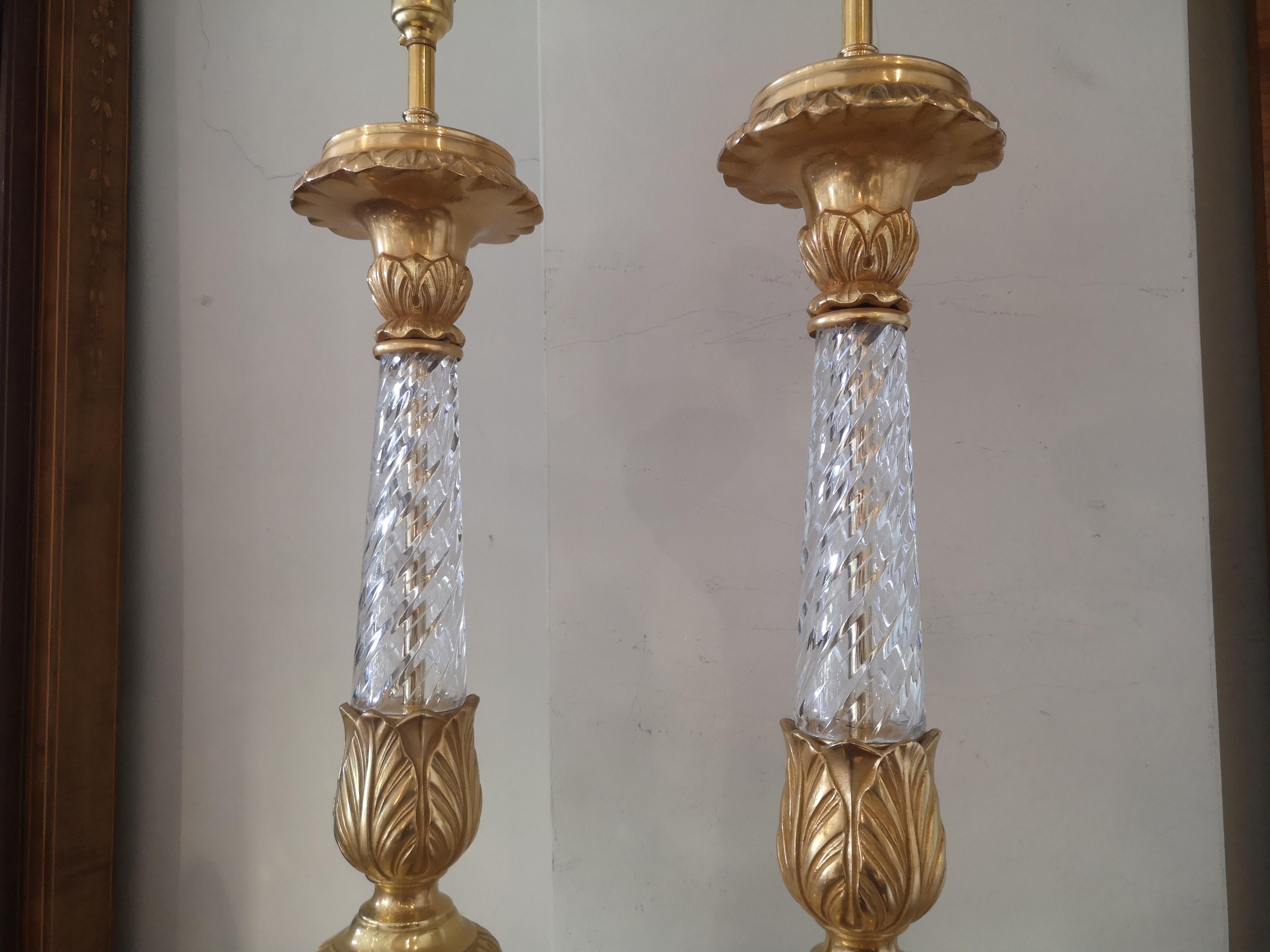 Pair of large early 20th century French crystal and gilded bronze lamps. The turned crystal stem with gilded bronze mounts and triform base with paw feet.
Recently re wired.
French, circa 1920.