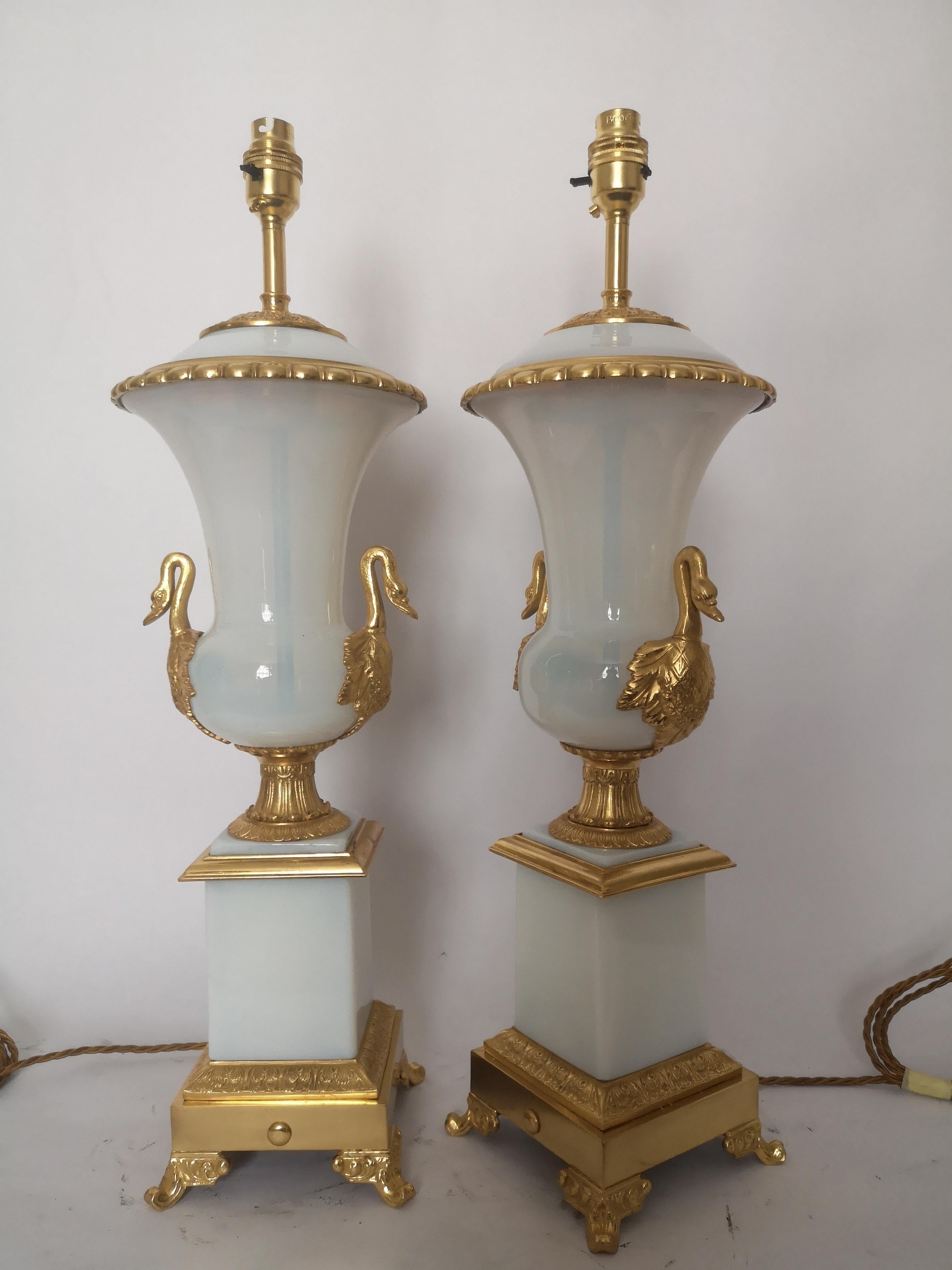 A fantastic large pair of opaline glass lamps, the baluster shaped body each with swan neck gilt bronze mounts, below a square section of opaline glass on a gilt bronze base and scrolled feet.
Recently rewired and PAT tested.
French, circa 1920s.