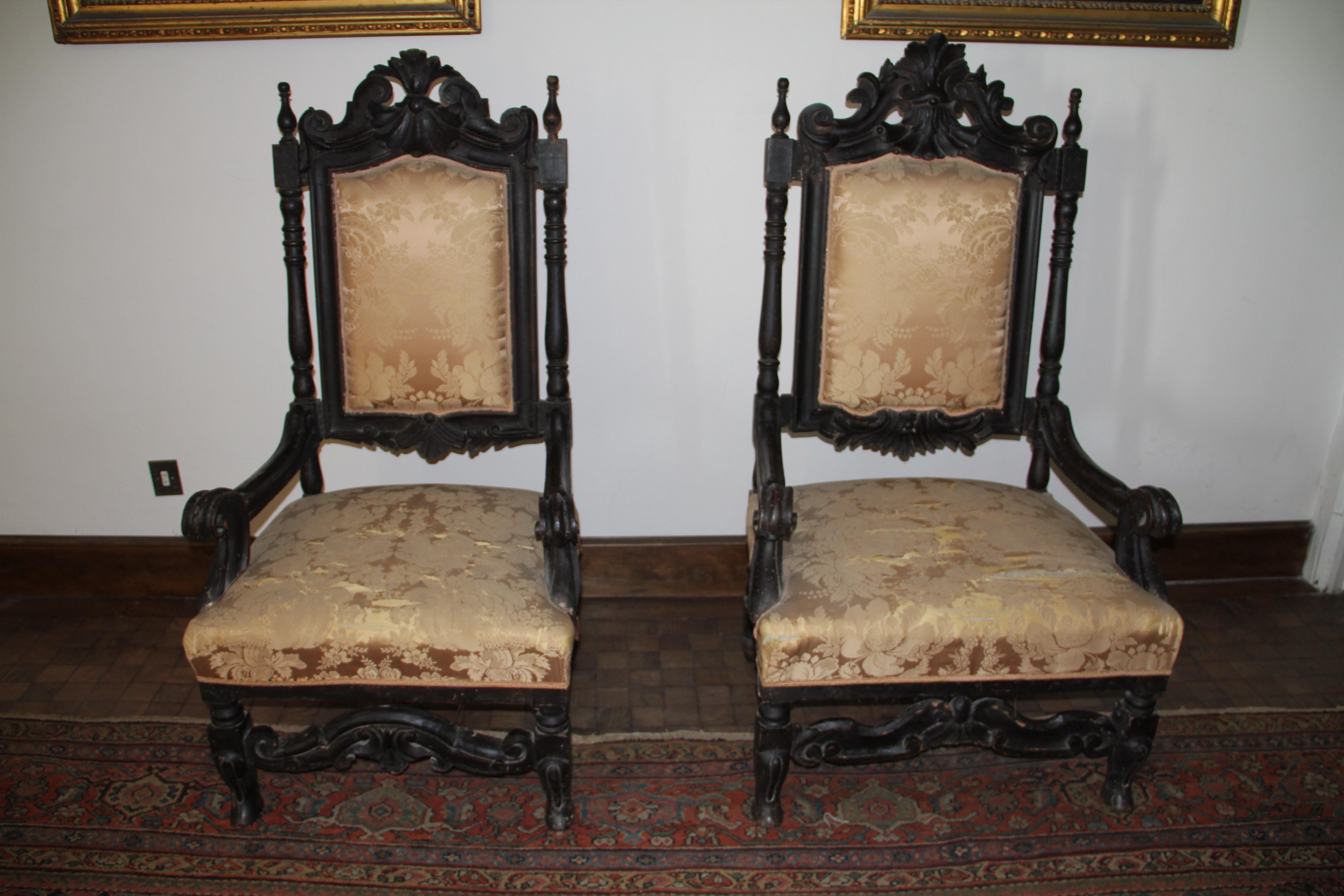Two large armchair ( male and female) one larger than the other ,with their tall backs and baroque carved decoration ,the shell and scroll-carved toprails above padded backs within baluster uprights over stuffed seats within serpentine arms, the