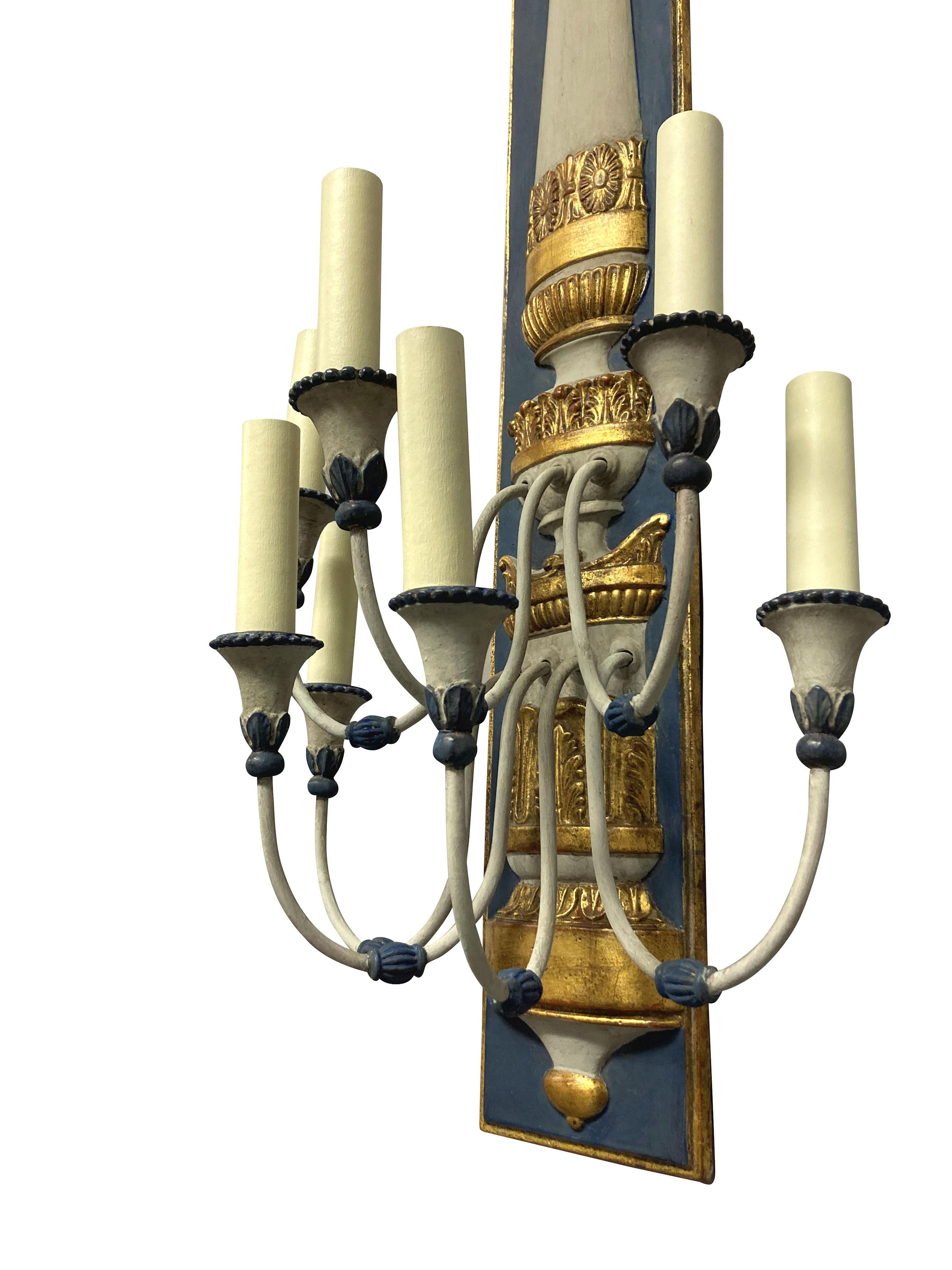 A pair of large French, Egyptian Revival wall lights. Each with seven branches, painted and gilded.