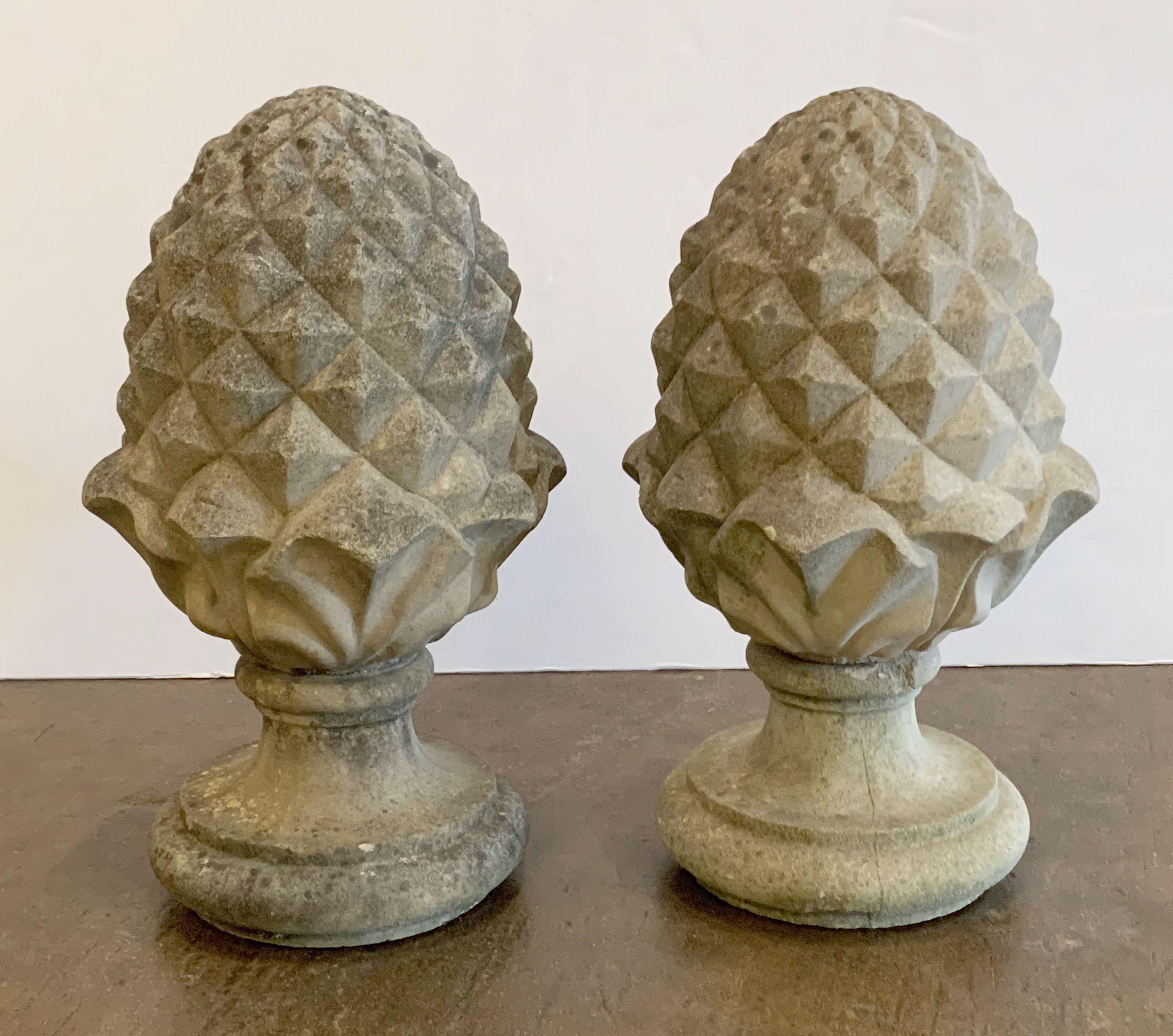 A fine pair of large English garden ornamental finials of composition stone, each finial featuring a stylized design of an acorn or pineapple or artichoke.

Two available - Individually priced - $2395 each finial.