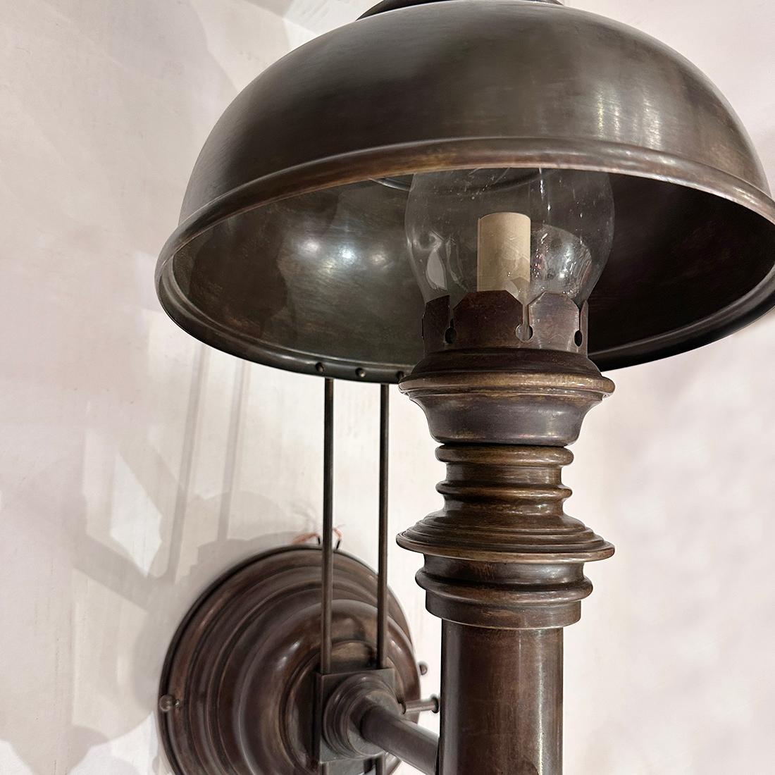 Pair of large English circa 1940's patinated brass sconces with adjustable shade and with glass hurricane.
Measurements:
Total Height: 28