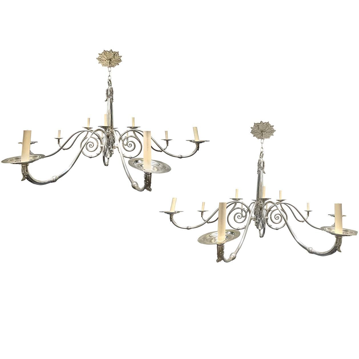A pair of circa 19th century English silver-plated bronze twelve-light chandeliers with scrolling arm motif. Sold individually.

Measurements:
Diameter: 63