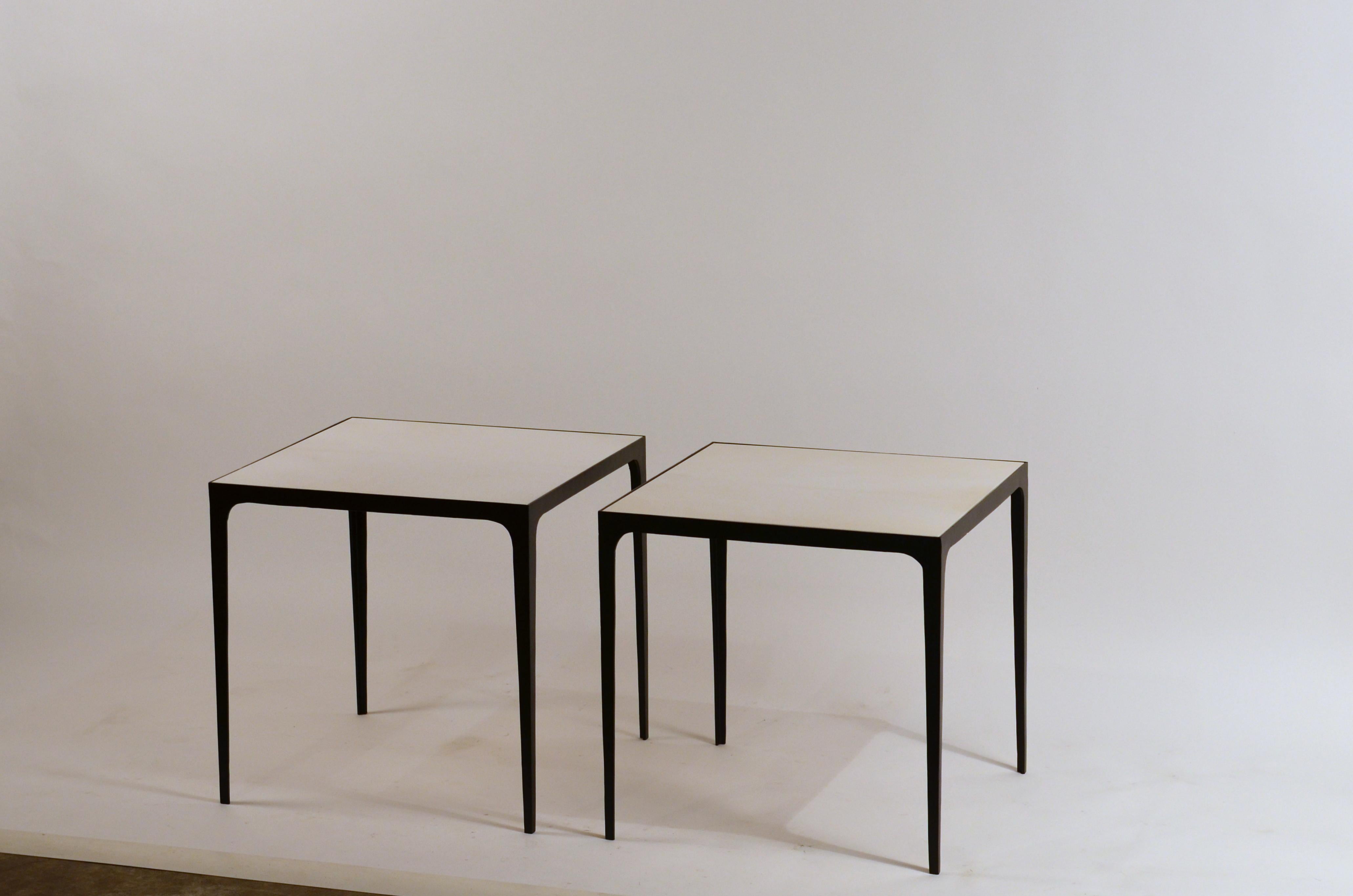 Pair of large 'Esquisse' wrought iron and parchment side tables by Design Frères. Also great as night stands.

Hand made, these elegant side tables combine chic slender blackened wrought iron bases with refined real parchment tops, adding an air