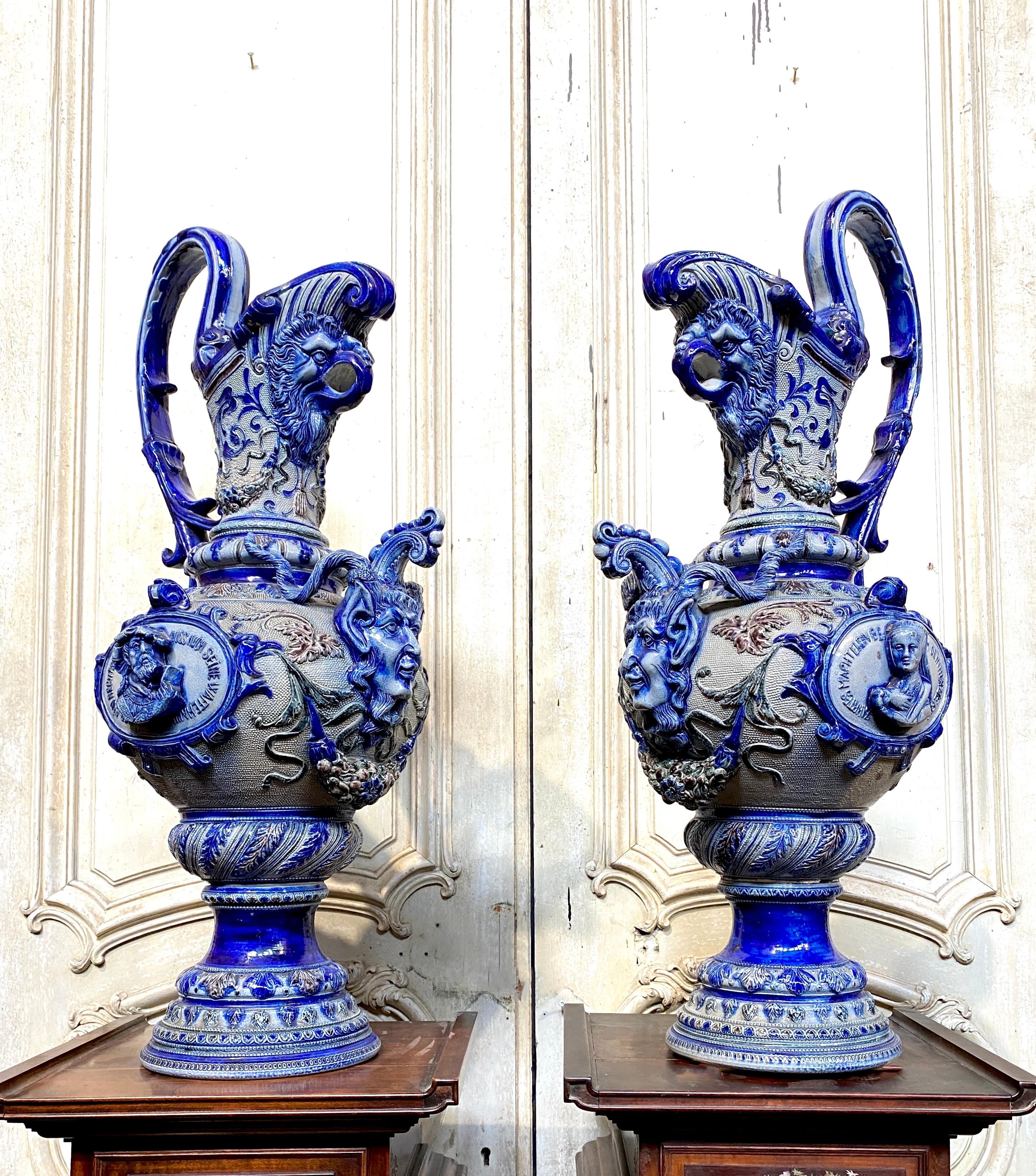 Pair of original Eastern stone ewers from the end of the 19th century. We find a rich decoration of birds' heads, raised foliage and blue faces emerging from a gray background with some purple reflections. Very good condition, no accidents and no