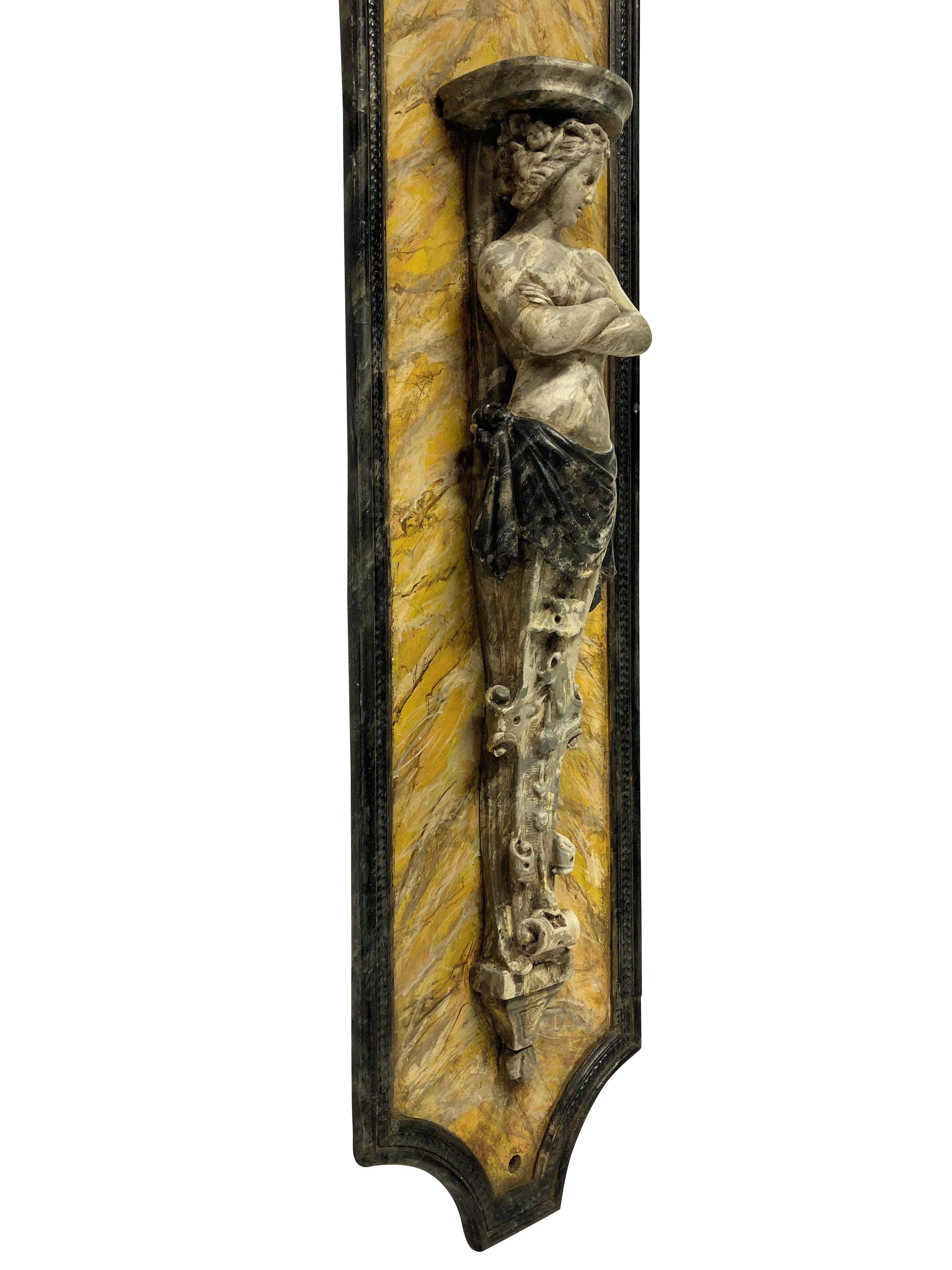A pair of large English Classical wall brackets in faux marble. Of wood and plaster, with Sienna marble back plates and grey marble figures.