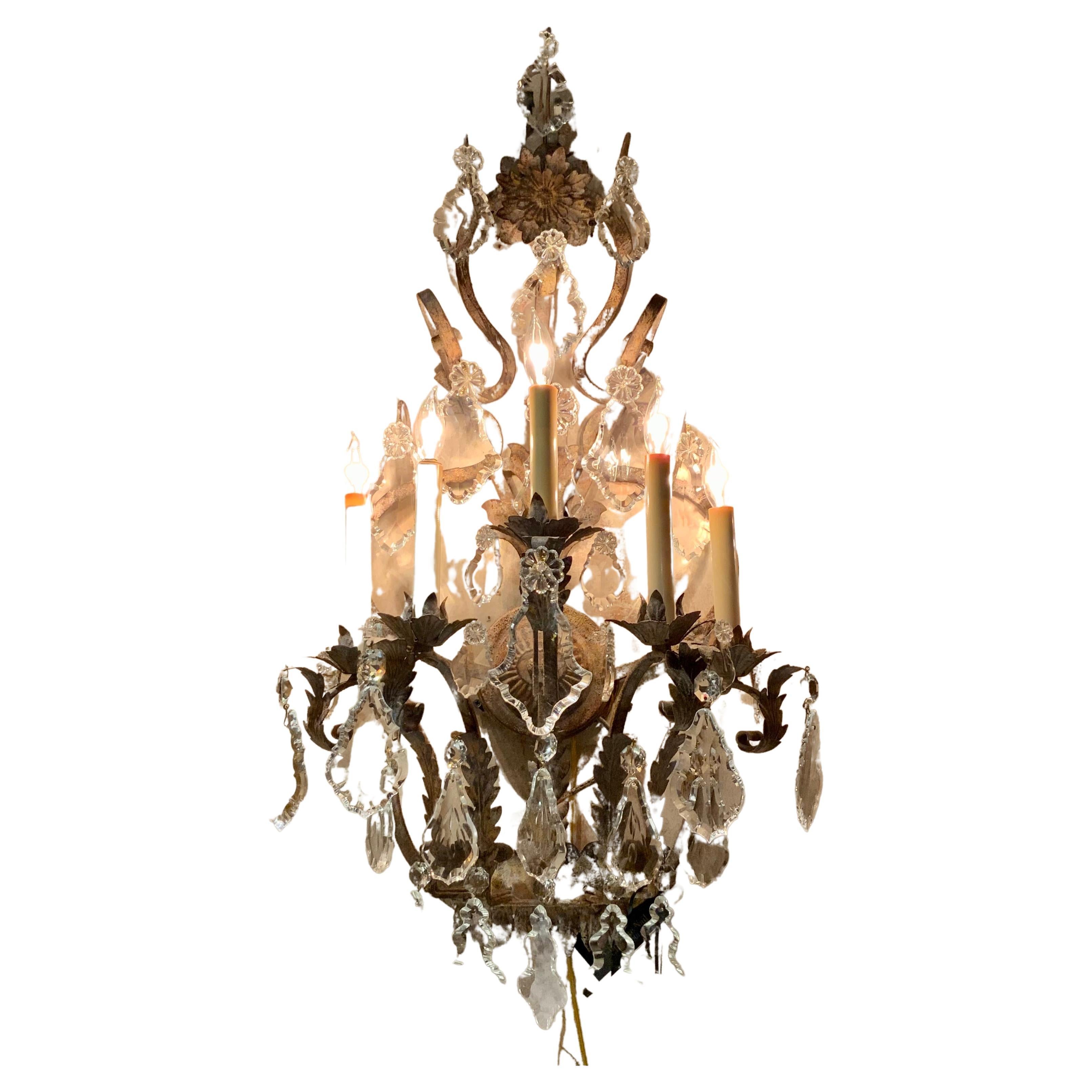 Pair of Large five light iron and crystal sconces with antique finish, wired For Sale