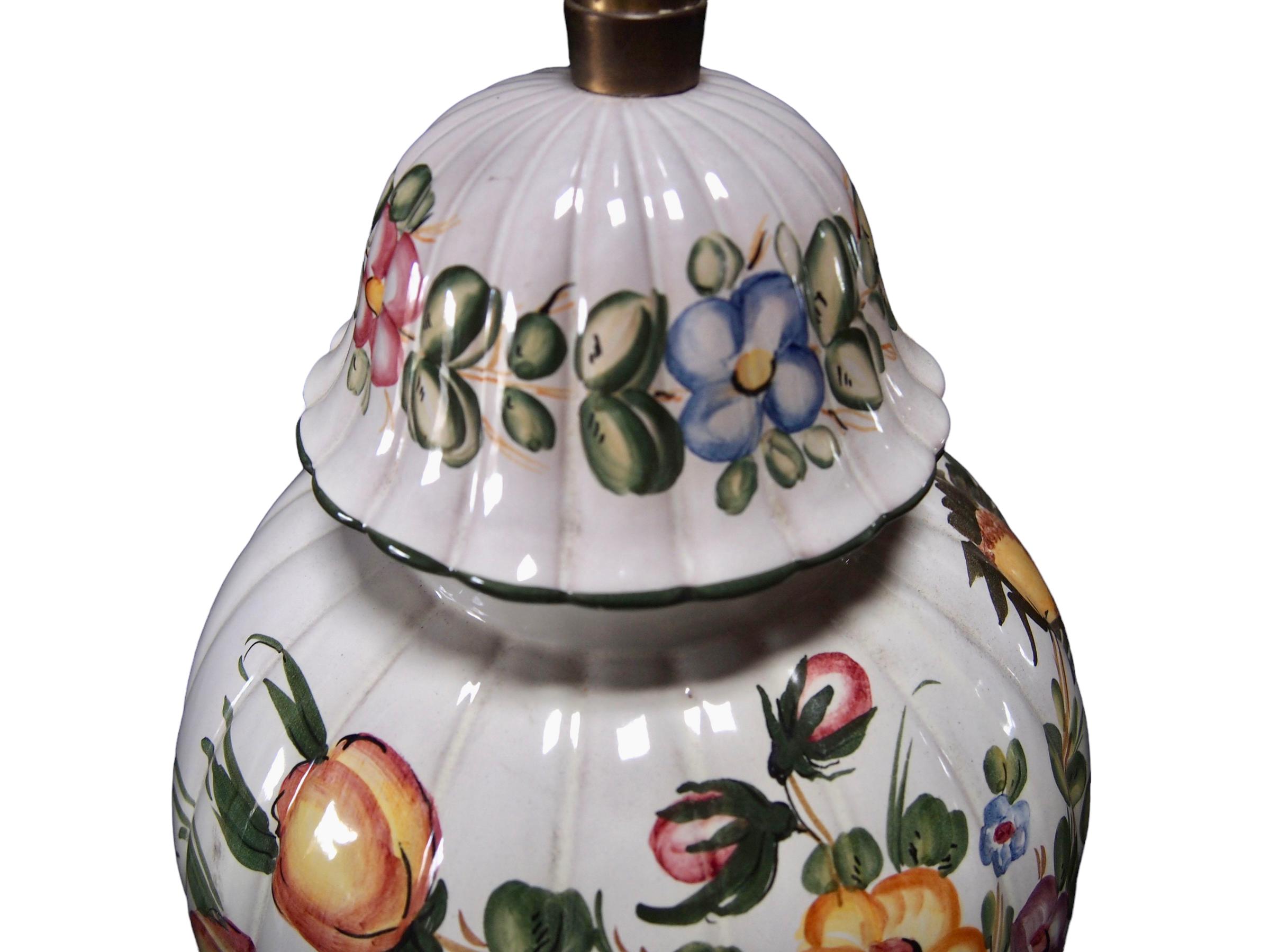 A fine and large pair of ginger jar hand-painted floral decorated lamps, made by Marbro Lamp Company Los Angeles. Each melon shaped ginger jar vase hand painted with brilliantly colored floral decoration resting on a wood base. Wired and in working