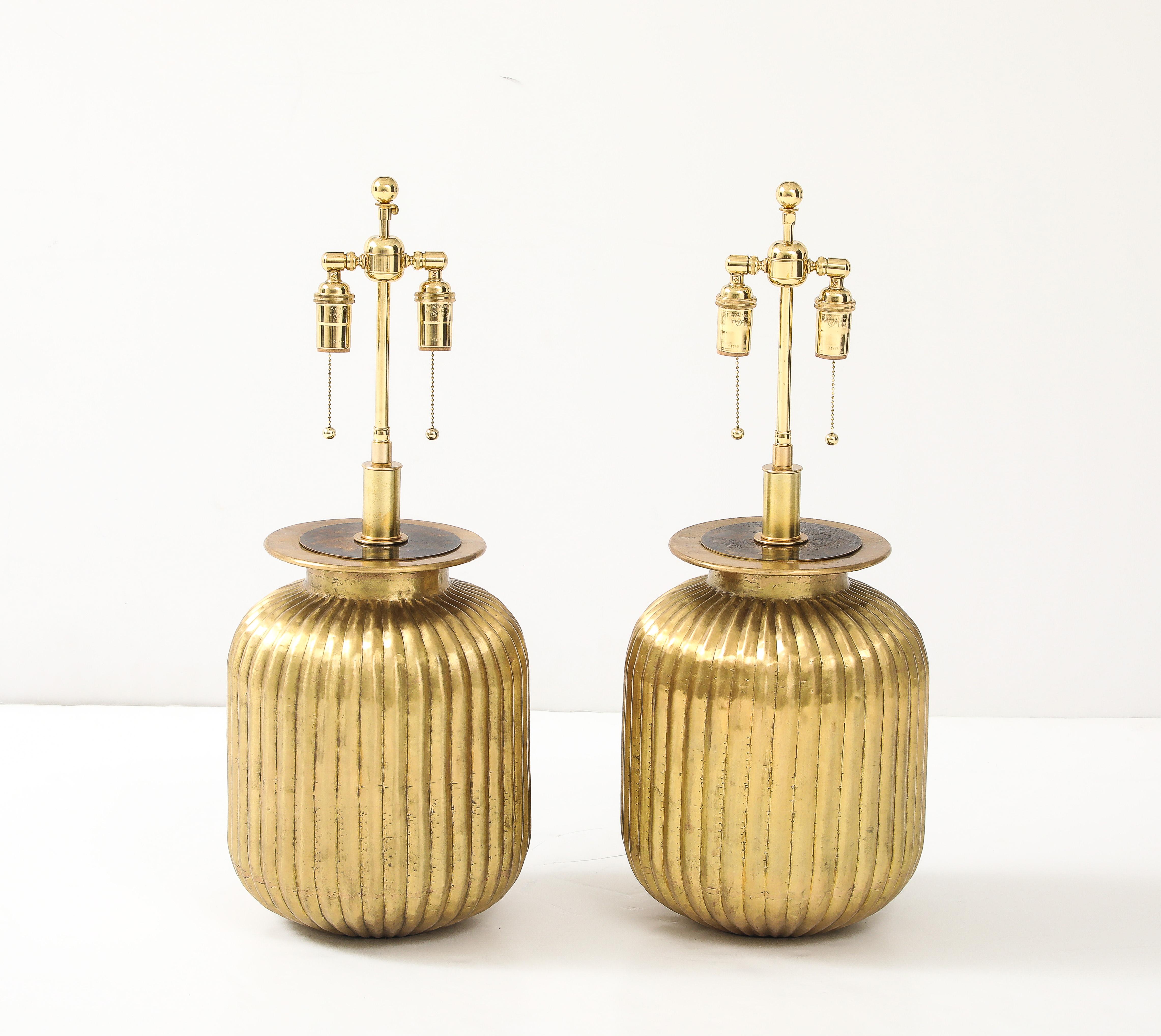 Wonderful pair of large fluted brass lamps with a beautiful Patina.
The lamps have been Newly rewired with adjustable polished brass double clusters 
that take standard size light bulbs and silk rayon cords.
The height to the top of the lamp body is