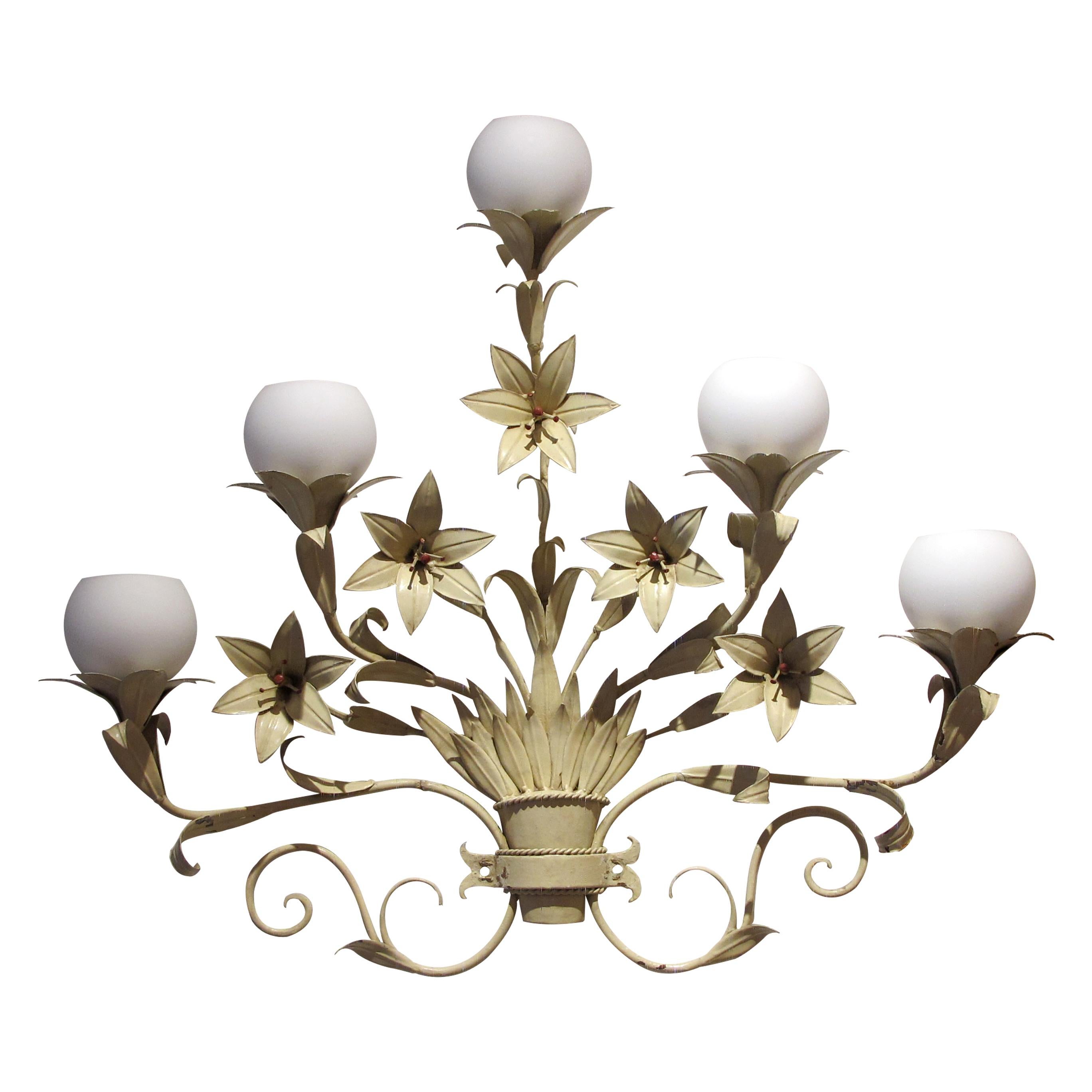 A highly decorative organic mid-century large pair of toleware French lilies wall lights. Each wall light is decorated with life-like foliage, scrolled metalwork and lily flowers. Each wall light holds 5 individual branches with 5 opaque round glass