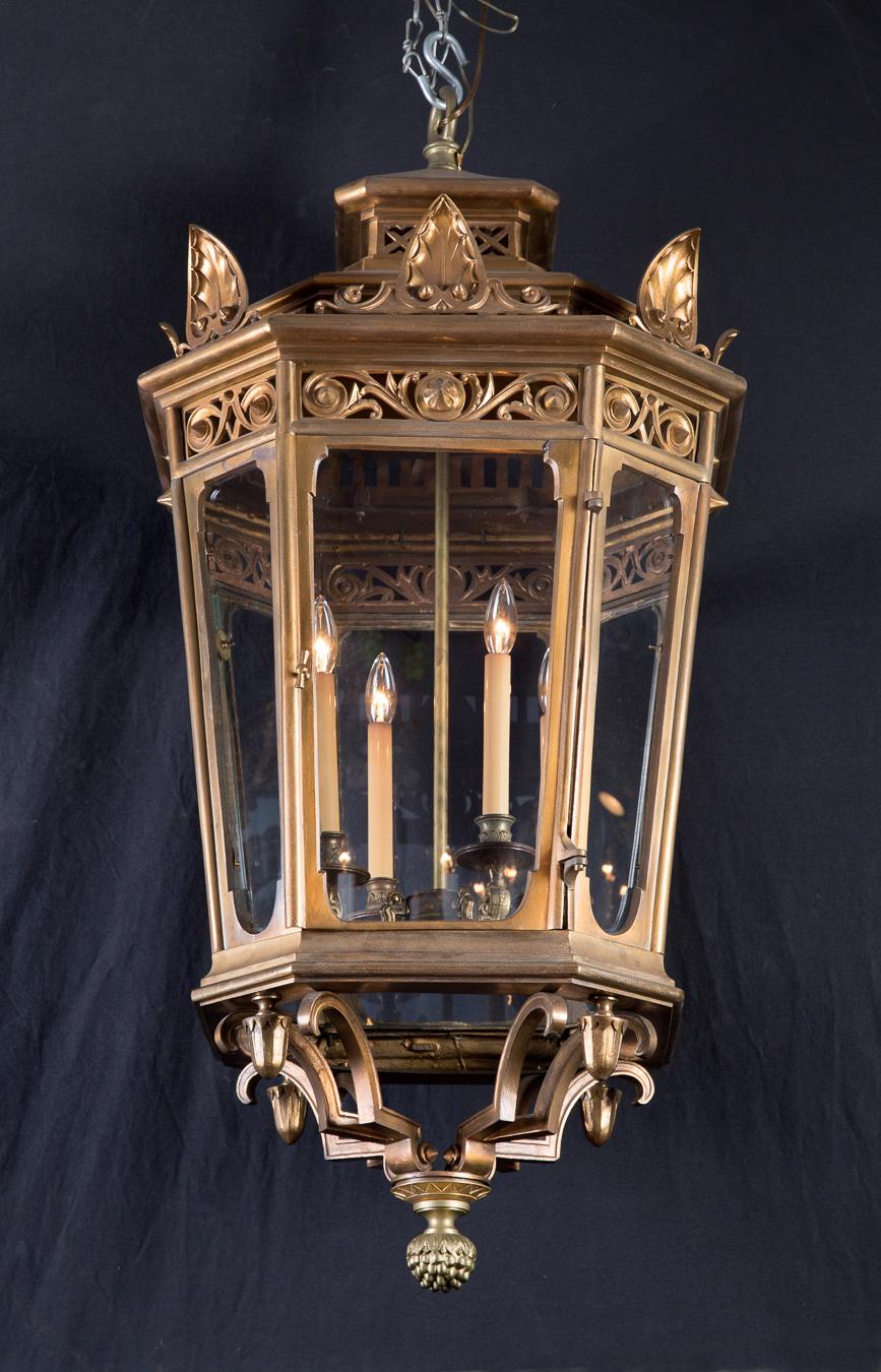 This fantastic pair of large Louis XVI octagonal lanterns are made of heavy solid bronze and date back to the 19th century. The French pair was originally gas burning and mounted atop a pair of gateposts but has since been converted to the hanging