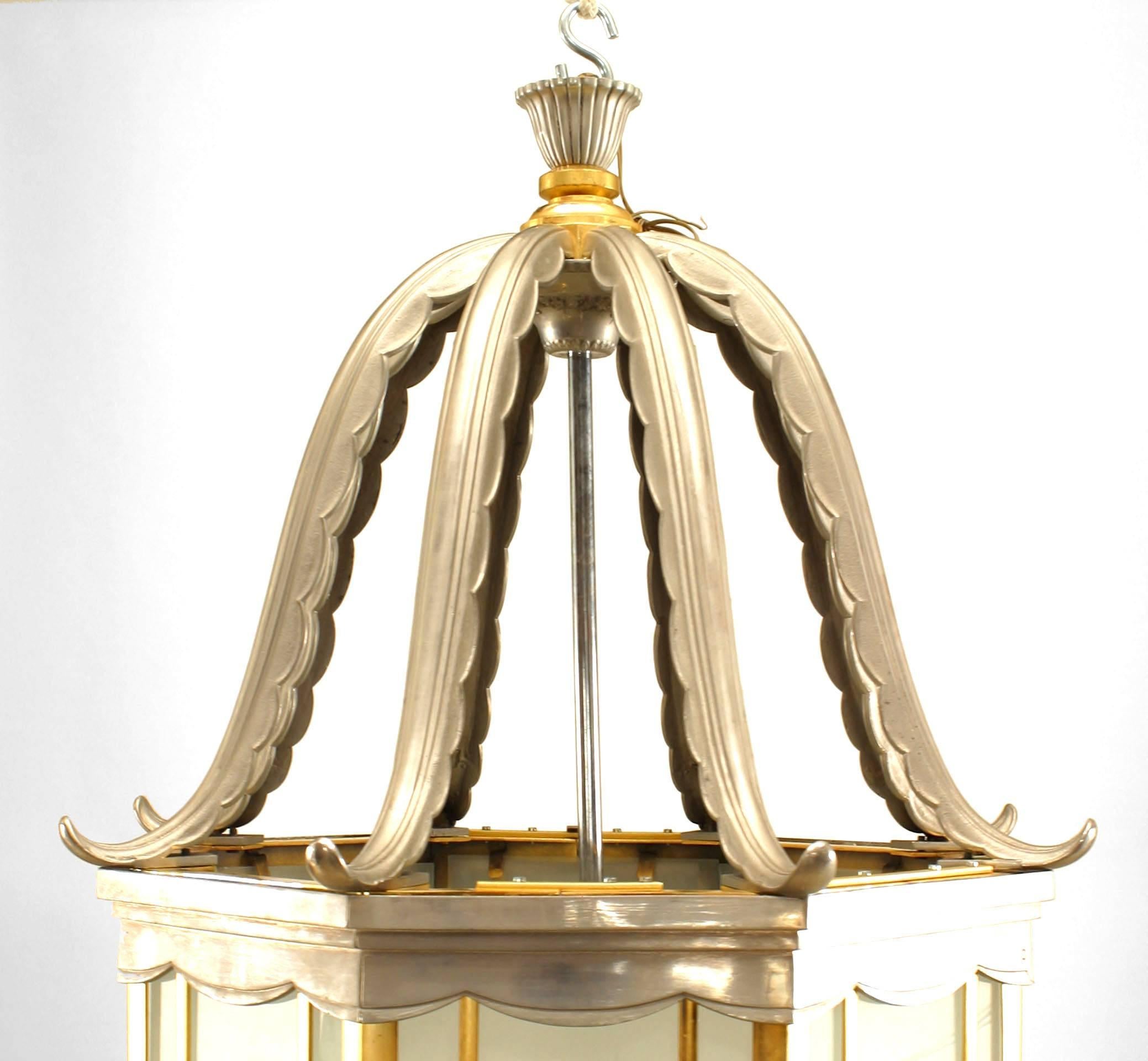 Pair of large French Art Deco brass and chrome trimmed 8 sided hanging lantern with frosted glass panels and finials on the bottom of each panel (PRICED AS Pair).
