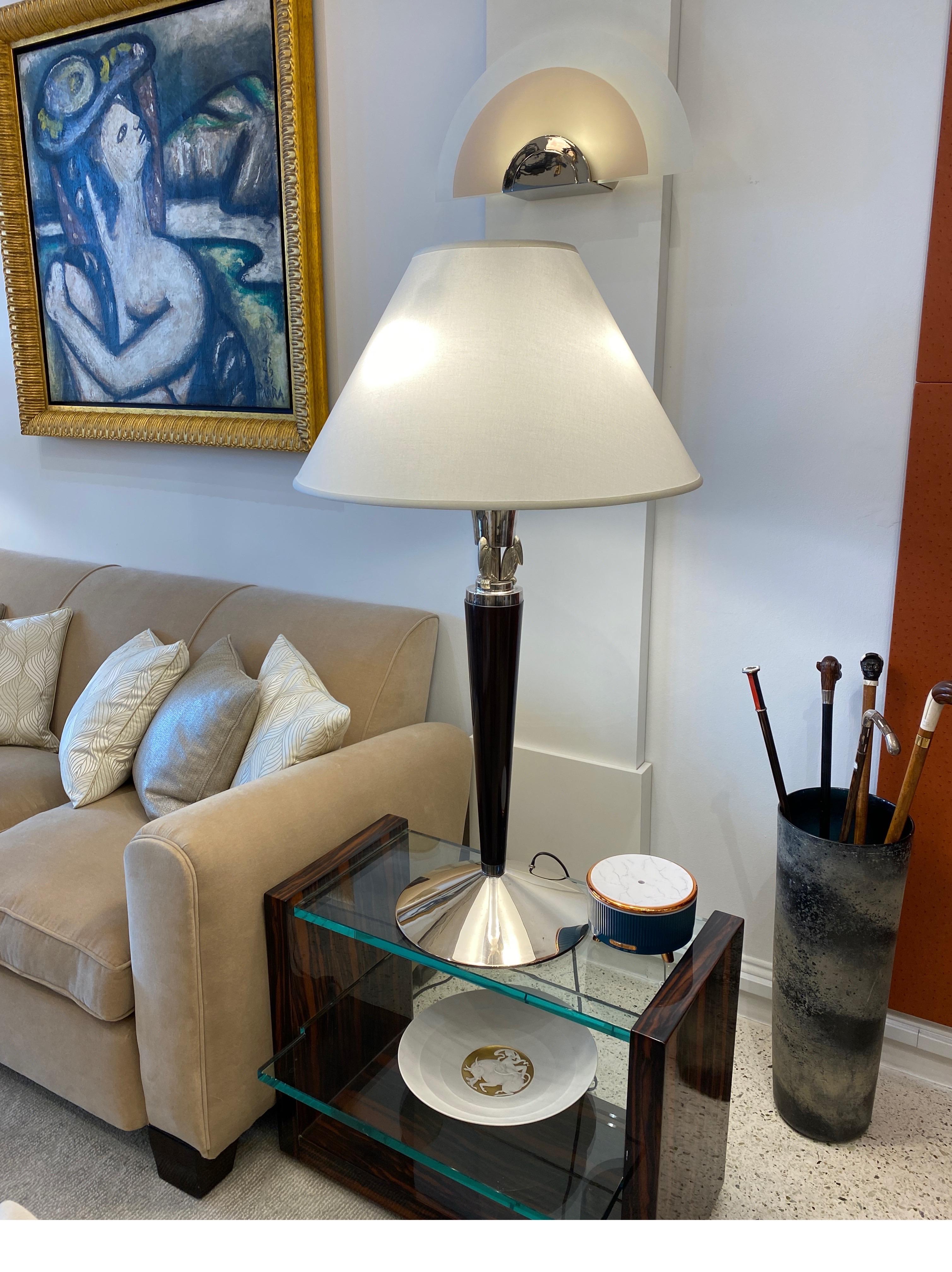 Pair of magnificent large scale French Art Deco table lamps by Atelier Petitot consisting of silver plated metal, rosewood shaft and 3 silver plated bronze exotic birds sculptures on the base of the bulb. Silk Shades.
Bronze maker Antonin Petitot