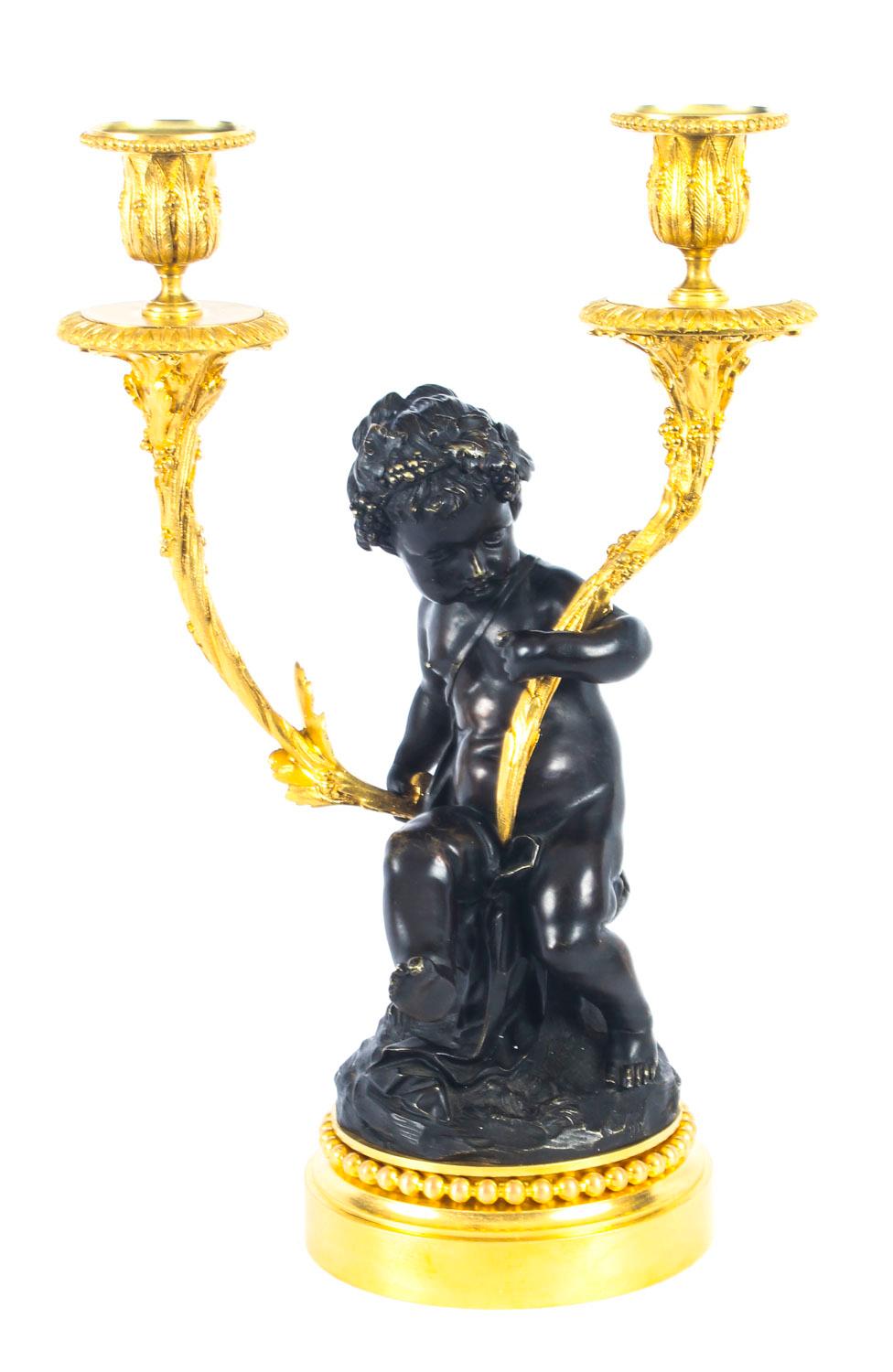 This is a fine quality large antique pair of French bronze and ormolu figural candelabra, circa 1840 in date.
 
The pair of superbly cast candelabra features a darkly patinated seated cherub and a darkly patinated standing faun each supporting a