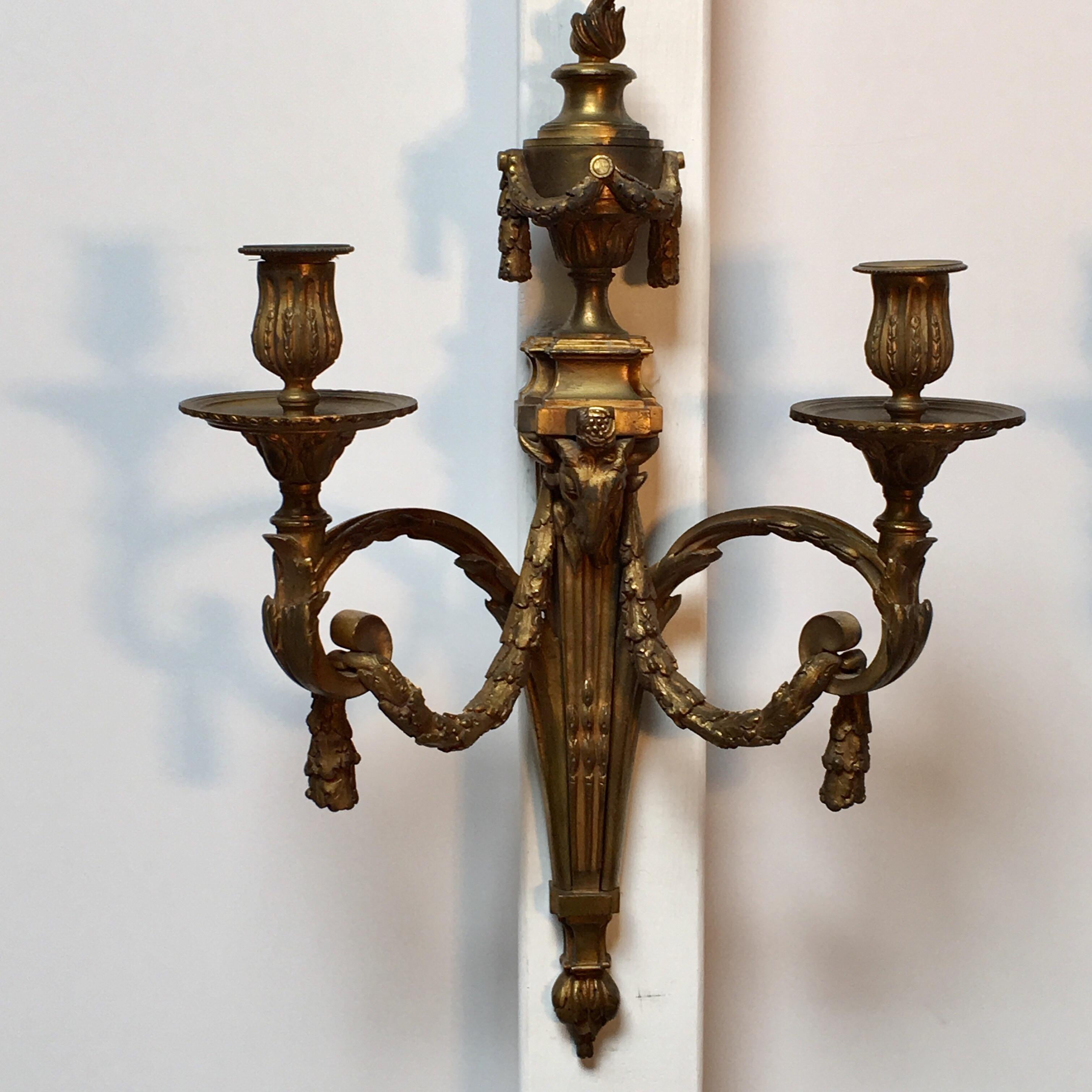 A pair of large French bronze two-arm Louis XVI style wall sconces.