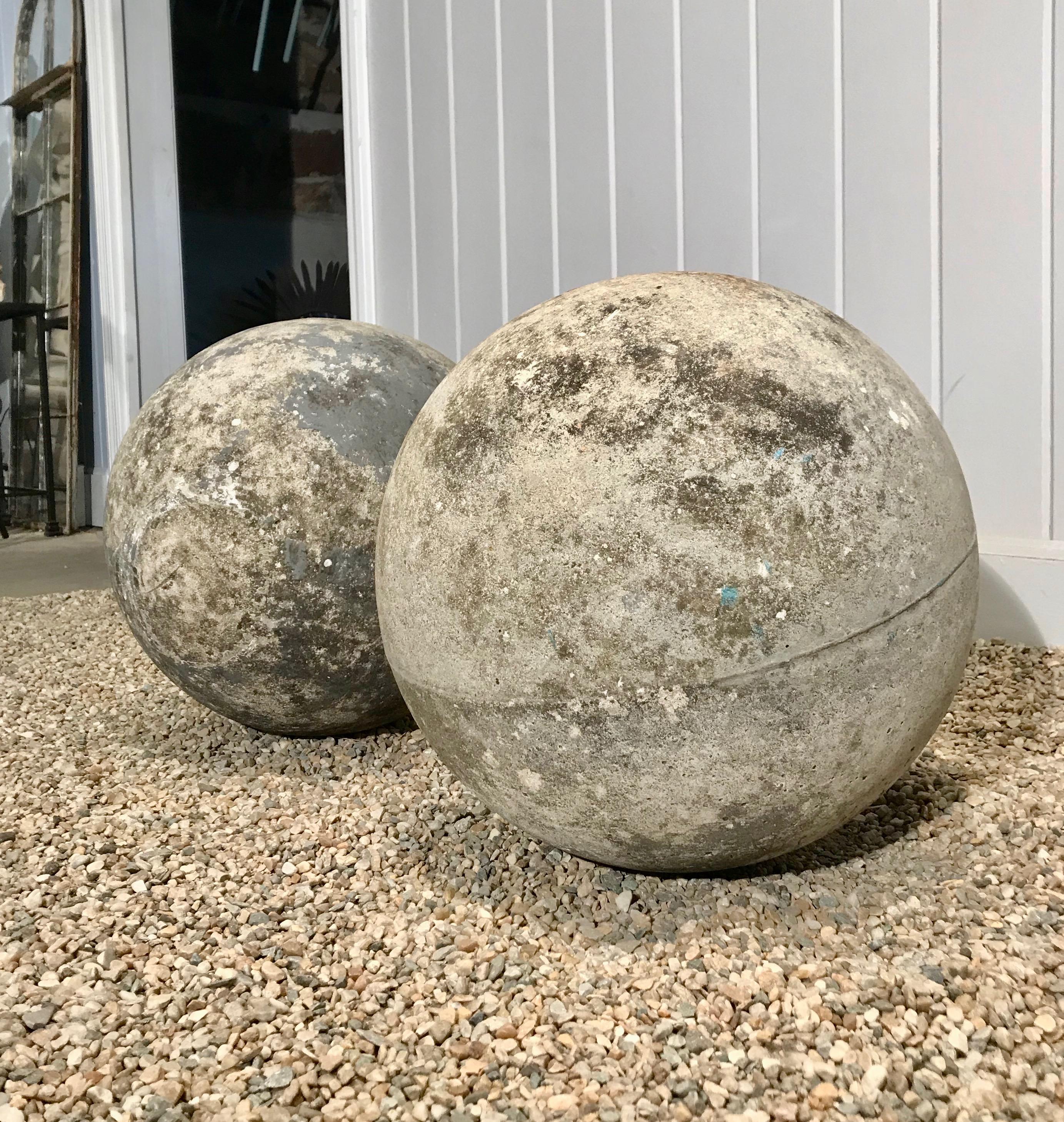 We love these cast stone balls for their large size (15 inches diameter) and lovely weathered surface. In very good vintage condition, they would be wonderful flanking the entrance to your garden or placed in a long flower border.