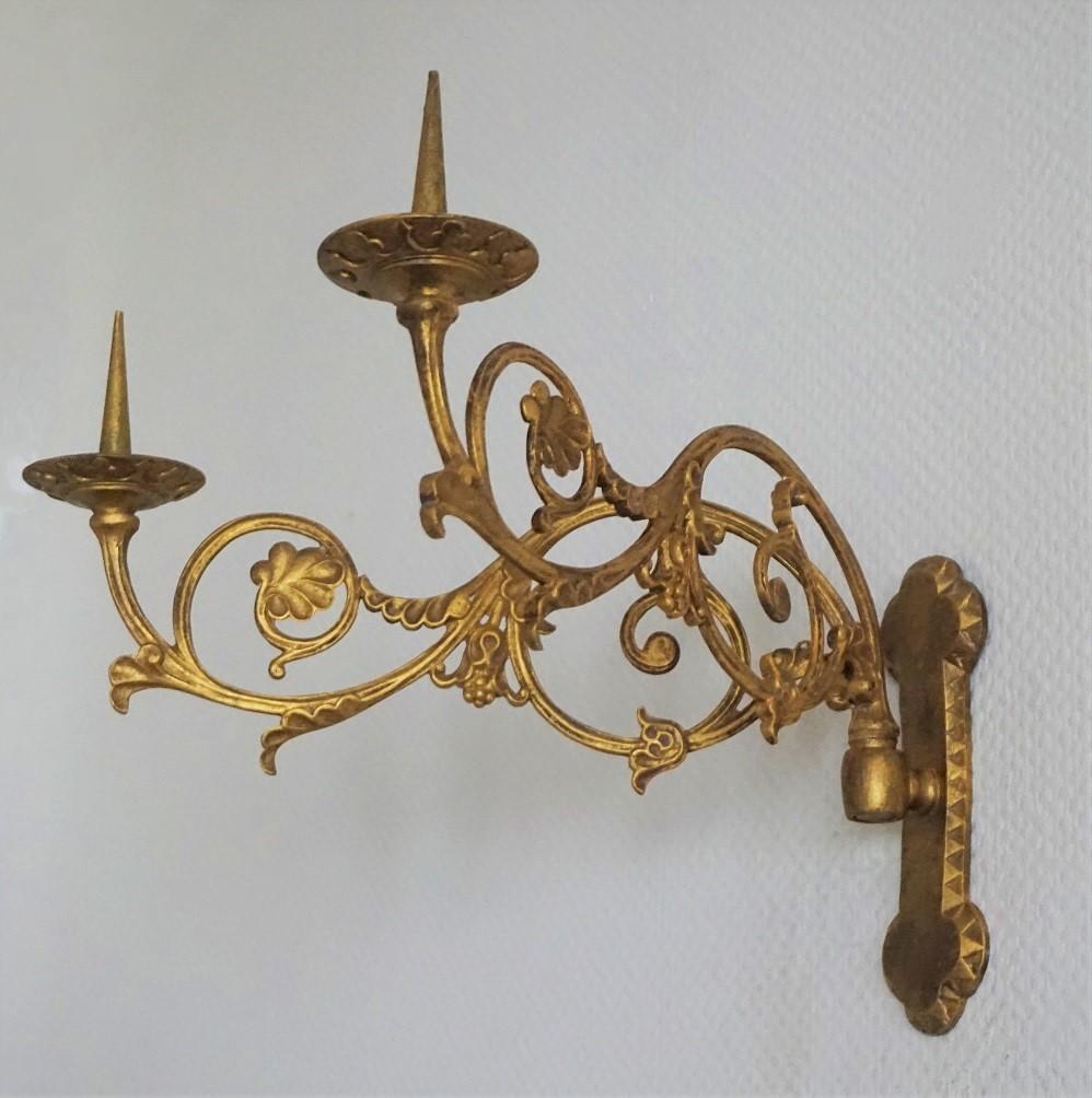 A pair of french church two-arm wall candle sconces, gilt bronze decorated with leaf motifs, beautiful aged patina, France, mid-19th century. For indoor and outdoor use.