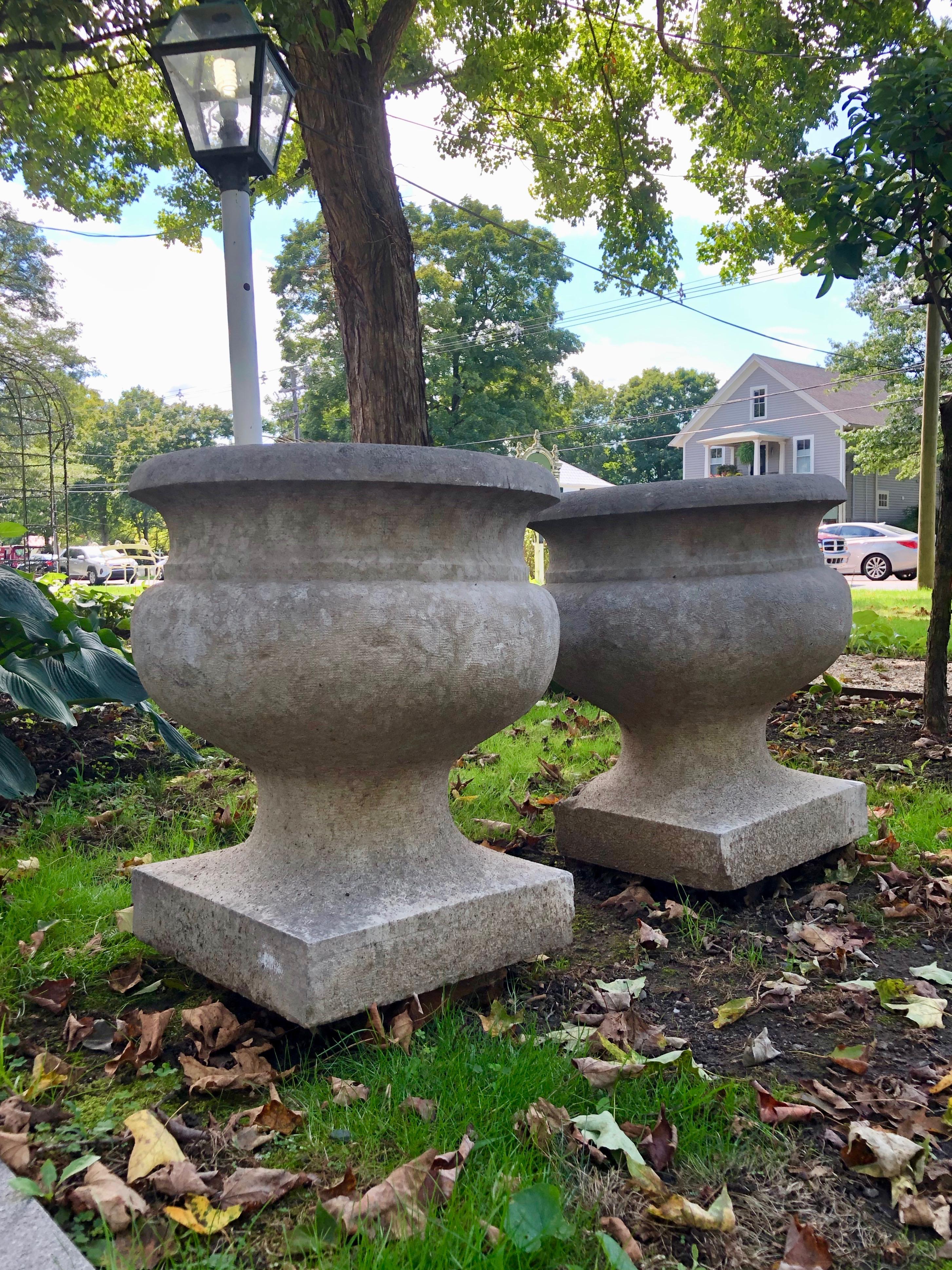This is a fabulous pair of urns, dating to circa 1800 and each is hand carved from a single piece of stone from Pierre de Bourgogne (Burgundy Stone). The stone is extremely hard, making it suitable for all climates and can be left outside year-round