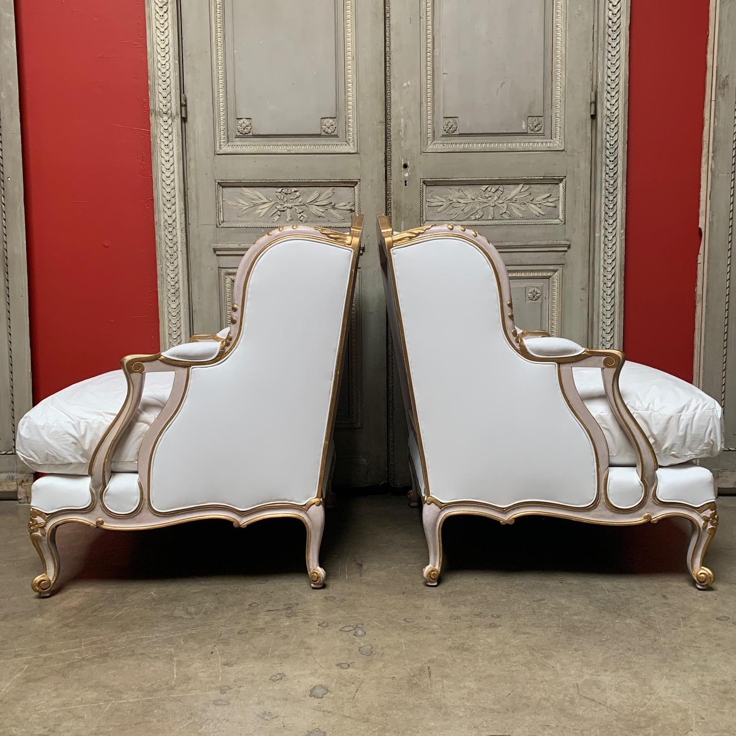 Hand-Carved Pair of Large French Louis XV Style Bergeres with a Pink and Gilt Finish For Sale