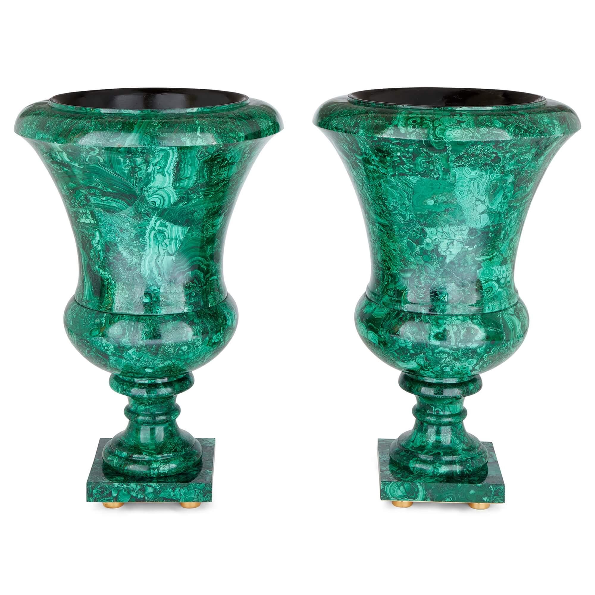 Pair of large French malachite vases 
French, 20th Century 
Height 77cm, diameter 50cm

Of campana form, this stylish pair of vases is crafted from malachite and gilt bronze. A malachite veneer covers the entirety of the vases, its bright green hue