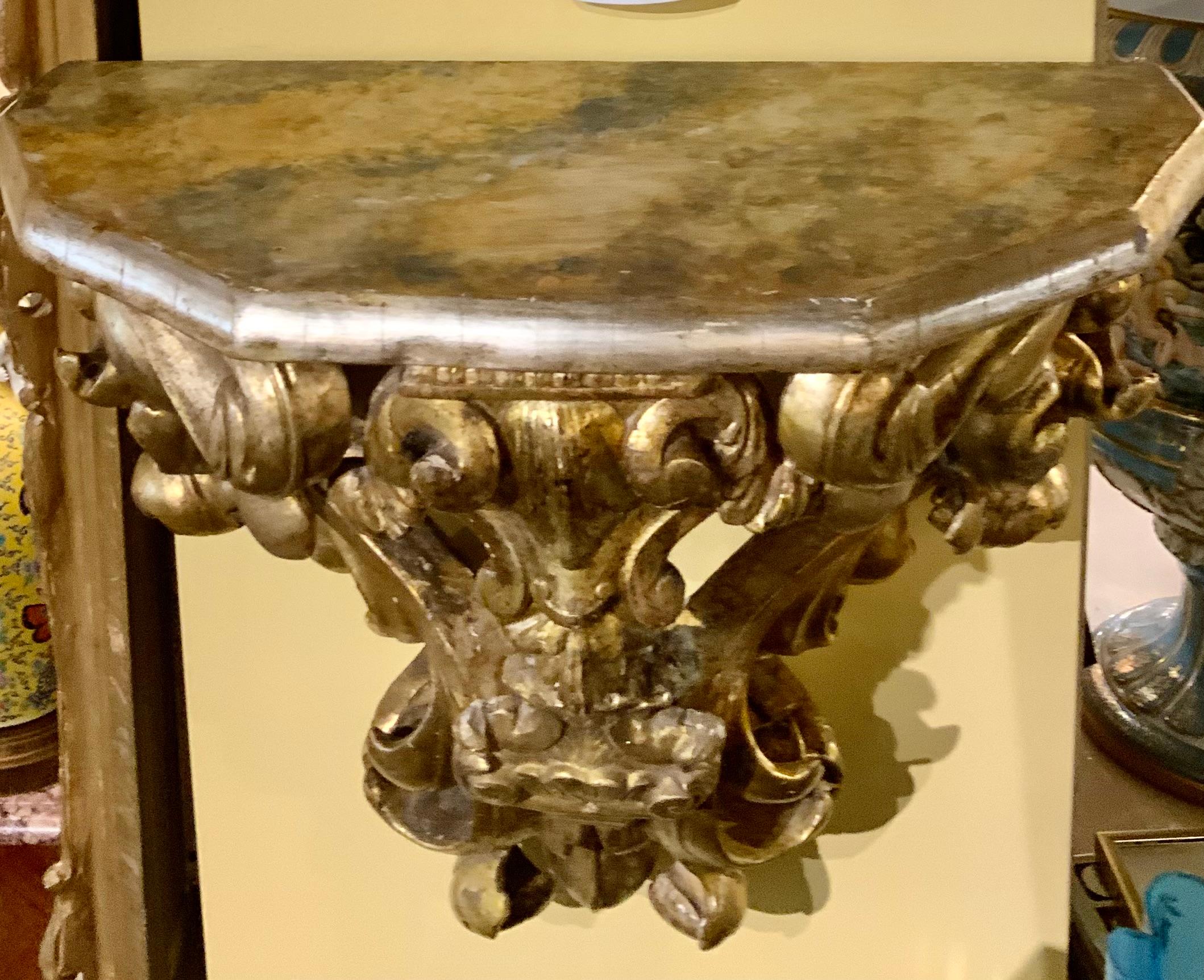 The gilding on this pair of brackets is original and beautifully executed 
The hand carving is well done and has many flourishing and scrolling
Curves that make the presentation appealing. The top of these brackets
Has been decorated in a faux