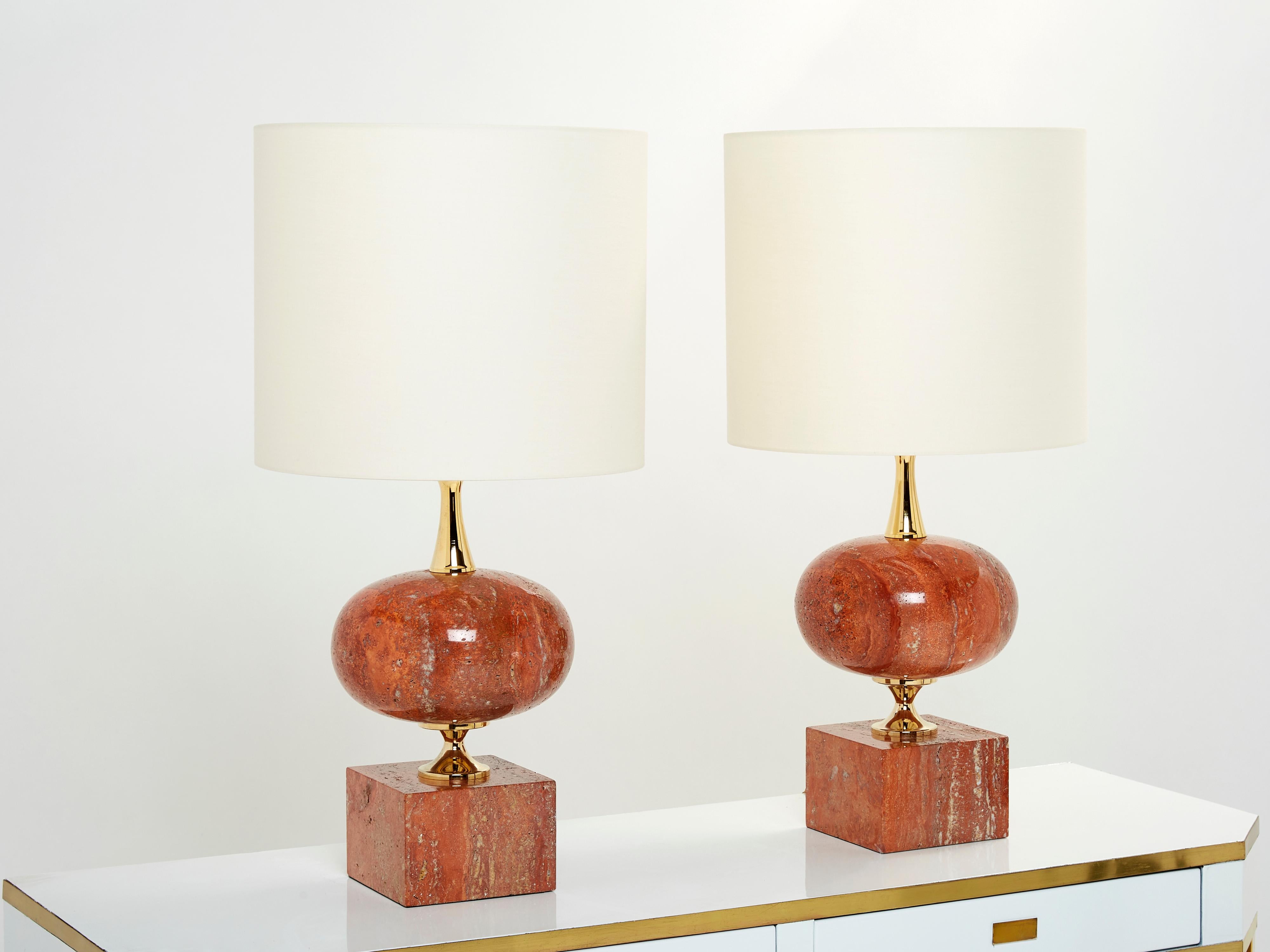 This large pair of lamps was designed by French lighting artist Philippe Barbier in the 1970s. Made out of rich red Italian travertine stone, with brass fixtures, these lamps are typical of Barbier’s designs. Glossy red travertine brings all the