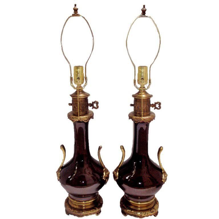 Pair of 1930s French Sang de Boeuf table lamps with original gilt bronze fittings. 
Measurements:
Diameter:8