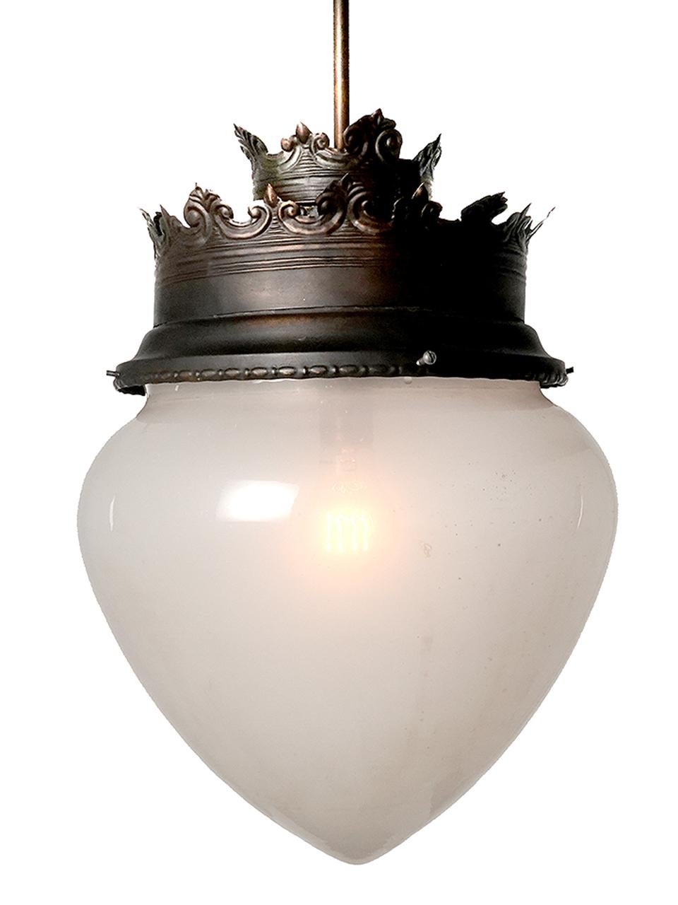 This is a unique matching pair of large frosted clam broth acorn globe pendent/chandeliers. The double crown shade holders are finished in a dark antique brass.  These are priced and sold as a matching pair.