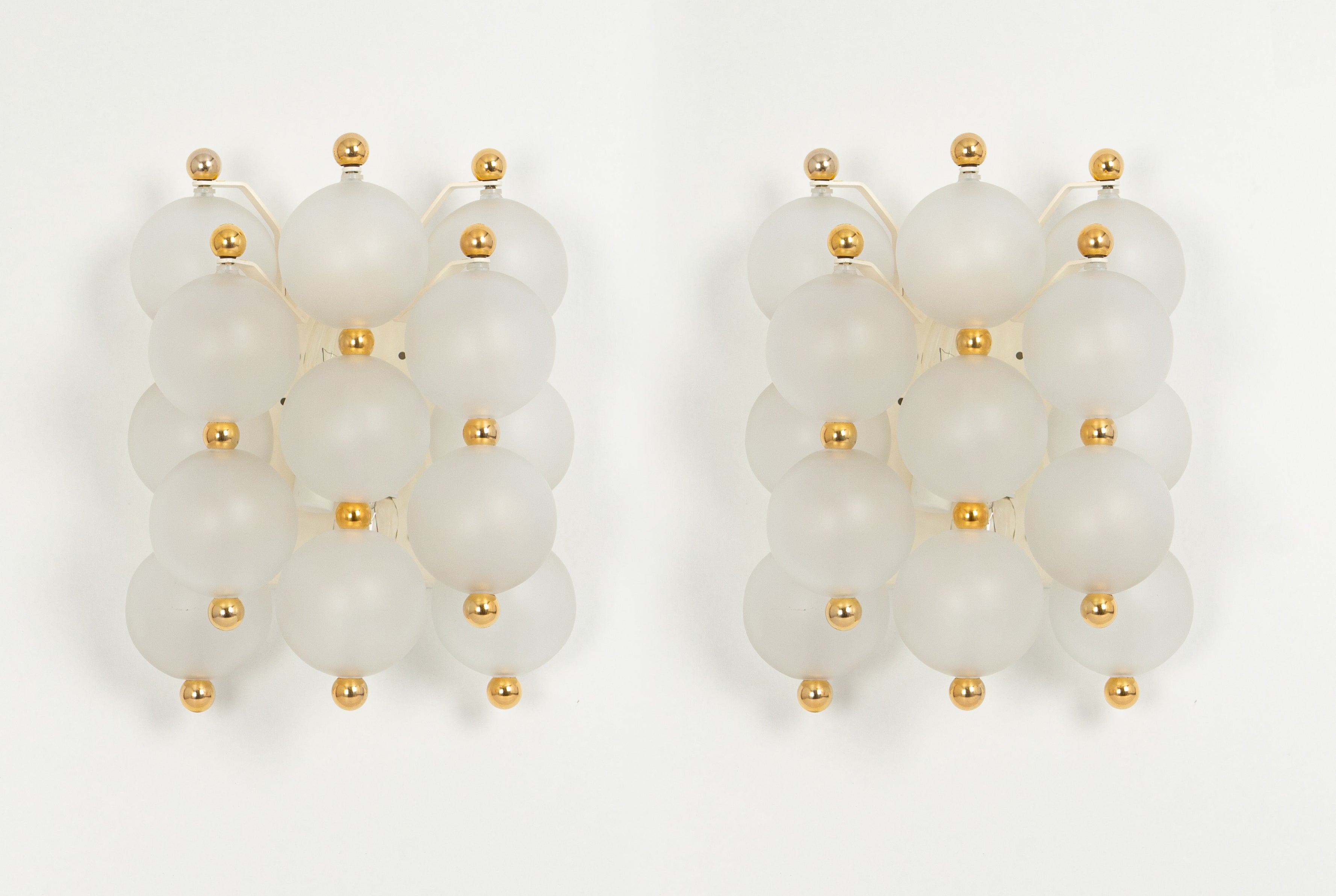 Wonderful pair of midcentury wall sconces with frosted glass balls, made by Kinkeldey, Germany, 1970s
High quality and in good condition with small signs of age and use on the balls and on the gold rings. Cleaned, well-wired and ready to use.