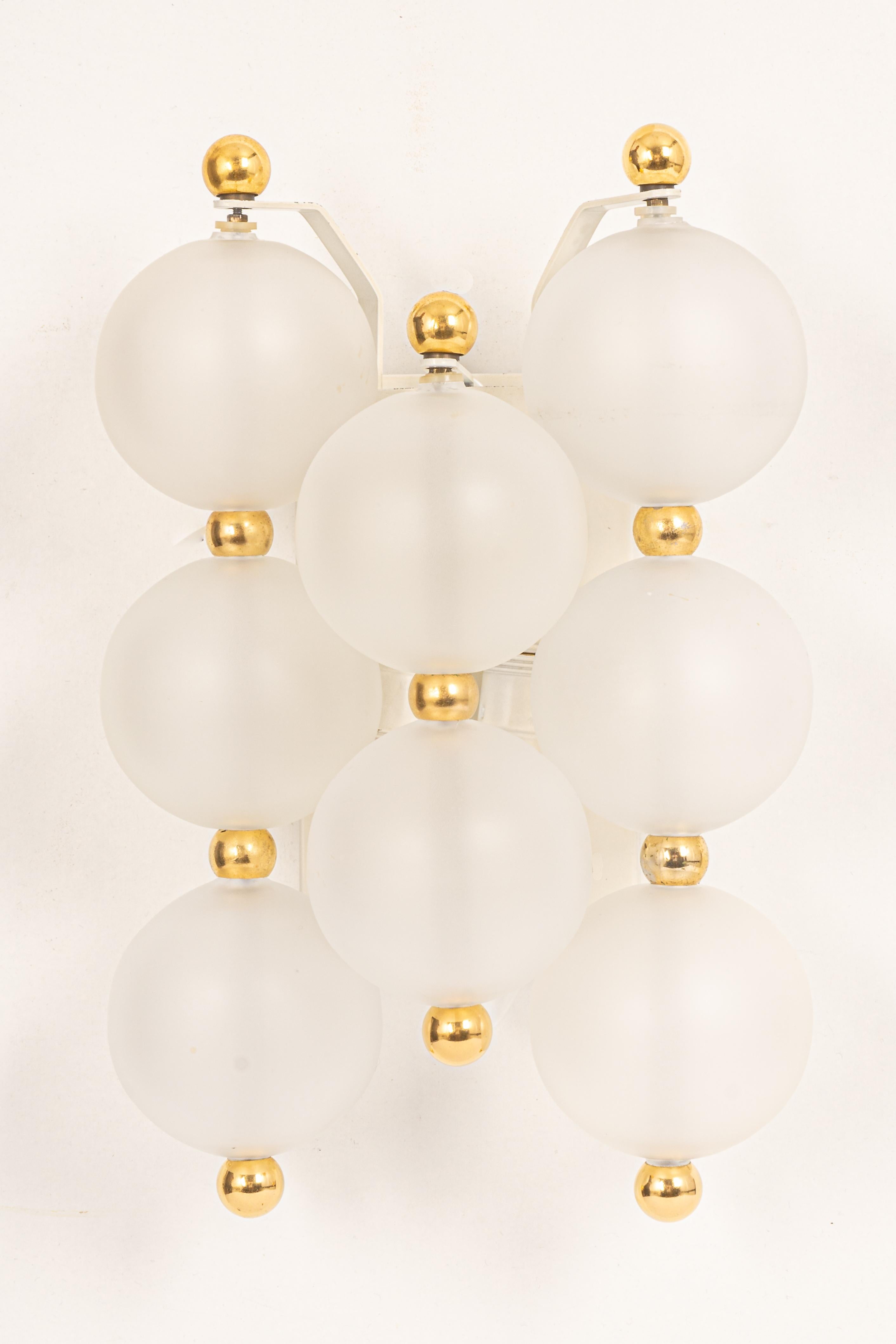 Wonderful pair of midcentury wall sconces with frosted glass balls, made by Kinkeldey, Germany, 1970s
High quality and in good condition with small signs of age and use on the balls and on the gold rings.(smalls scratches). Cleaned, well-wired and