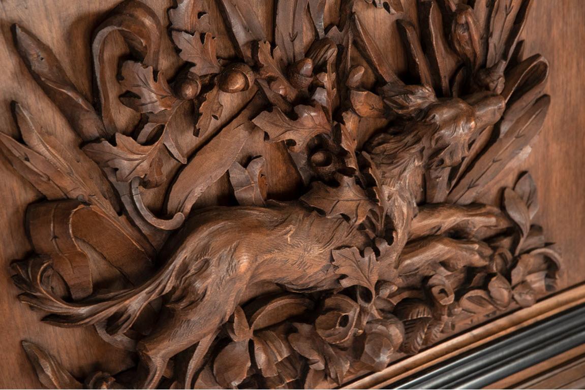 Each French walnut panel centers on a richly carved high-relief carving of hunting game surrounded by a carved foliage frame.

Measures: 35 12 x 48 3/4 x 6 inches.