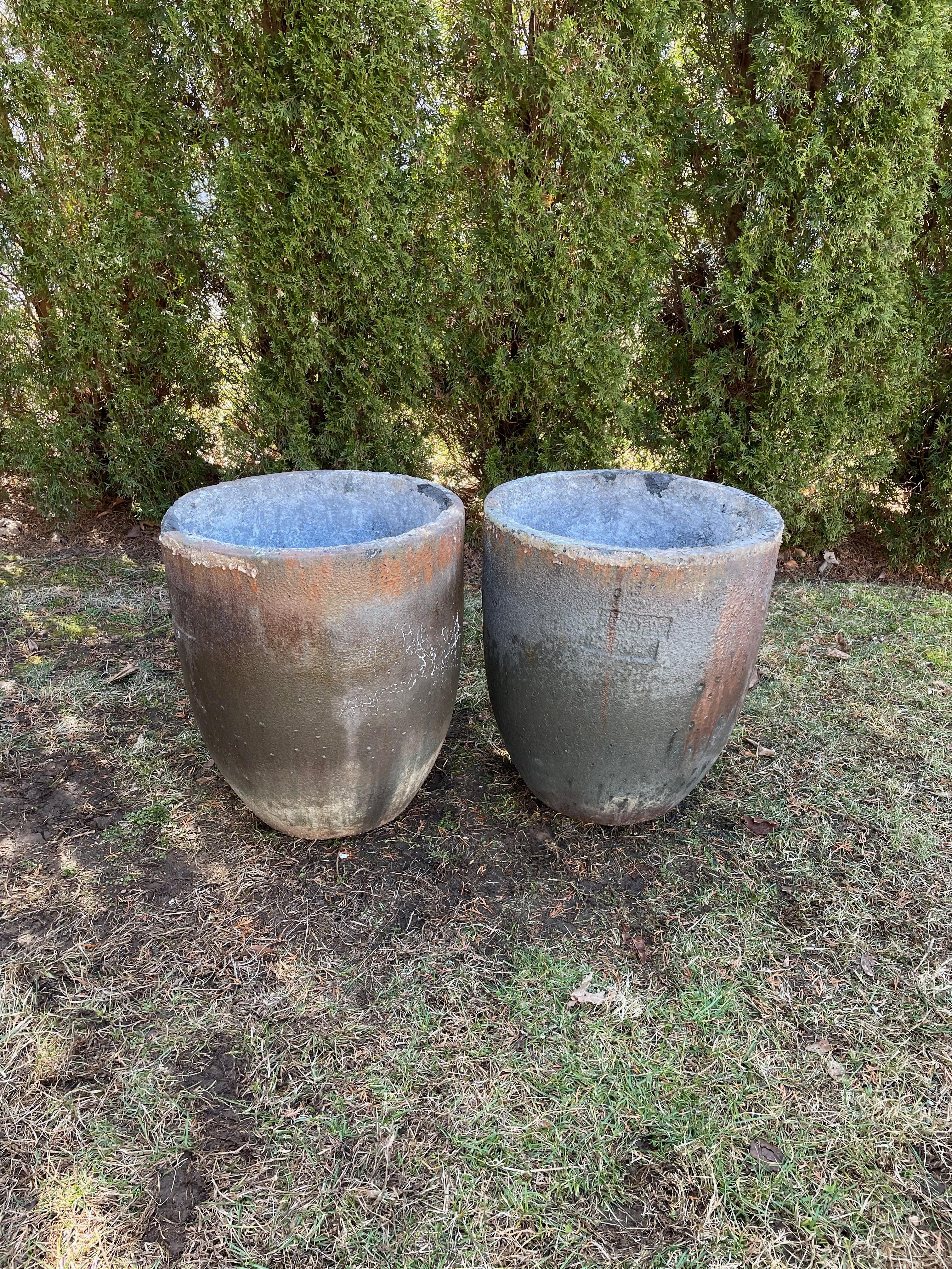 Crucibles have been used through history to smelt metal and other substances, but the ceramic ones make outstanding planters (and fire pits). This pair has a dark mottled coppery-colored hue with a subtle sheen to the surface and commodious planting